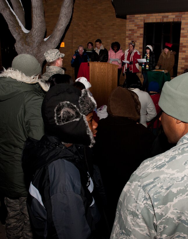 Choir members and volunteers sing Christmas carols at the 28th Bomb Wing Christmas Tree Lighting Ceremony in front of the Freedom Chapel on Ellsworth Air Force Base, S.D., Dec. 1, 2011. Airmen and their families from across the base gathered for the event that kicks off the holiday season. (U.S. Air Force photo by Airman 1st Class Kate Thornton/Released)