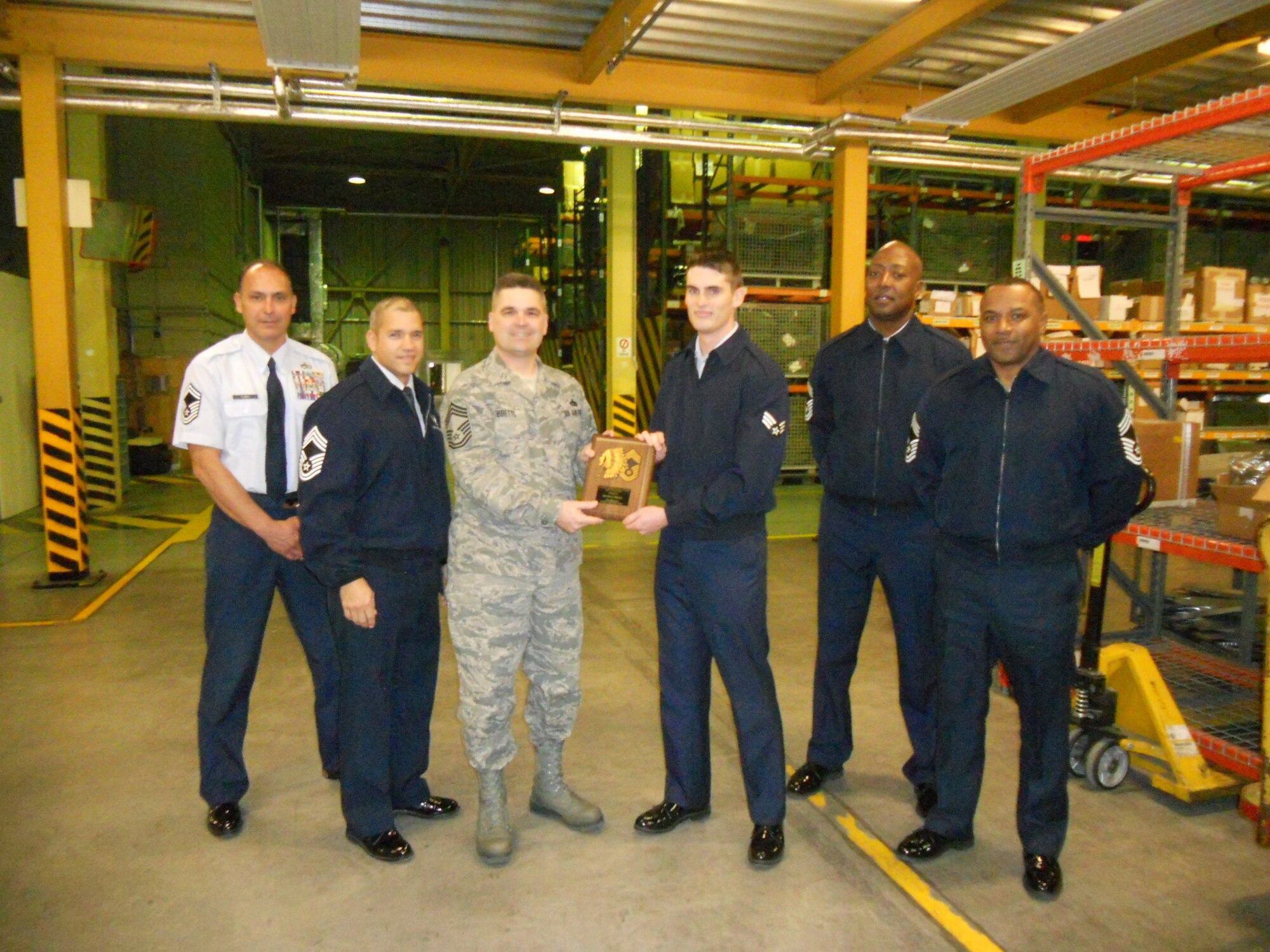 Senior Airman Joel Barrott, 31st Logistics Readiness Squadron maintenance support liaison, receives the Aviano Chiefs' Choice Award for November from the Aviano Chiefs' Group. Aviano chiefs present the Chiefs' Choice Award monthly to an Airman who clearly exceeds Air Force Standards in the areas of dress and appearance, military bearing and exceptional behavior in performance of their duties and in relationships with others. (Courtesy photo)