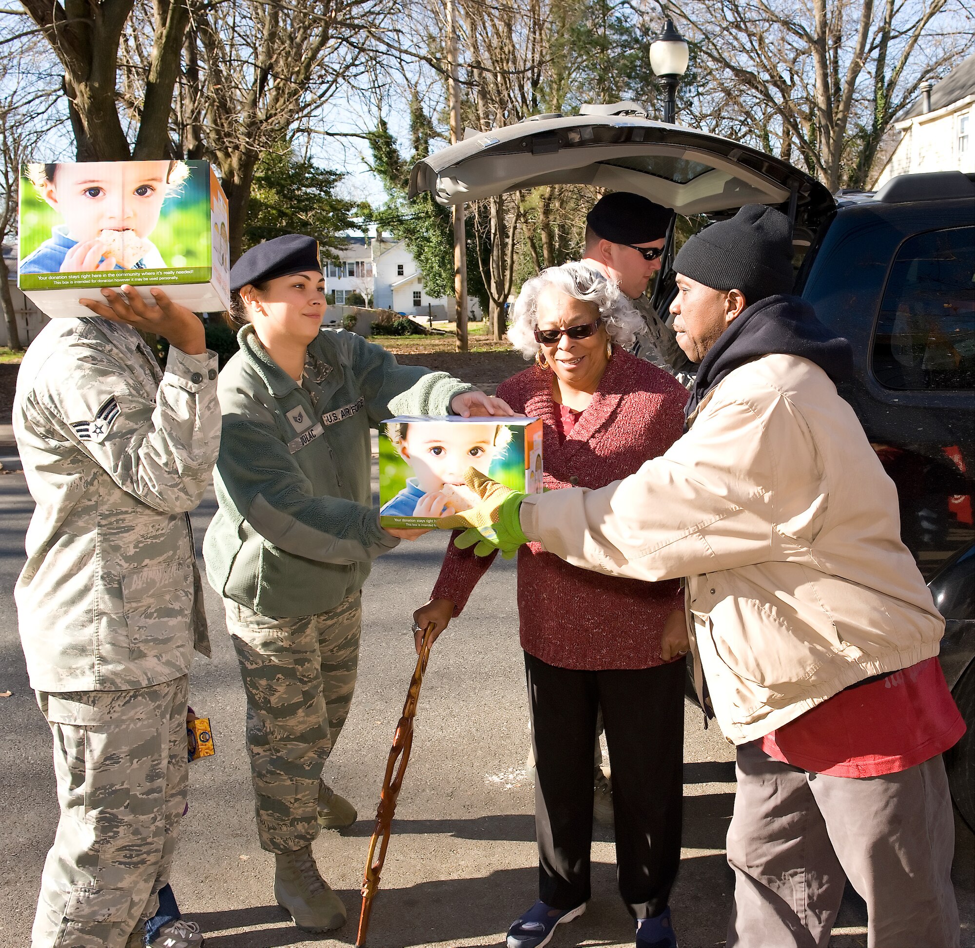Members of the 436th Security Forces Squadron at Dover Air Force Base, Del., deliver more than 600 non-perishable food items to the House of Pride Dec. 2, 2011. This was the third year 436th SFS members held a food drive for the House of Pride. (U.S. Air Force photo by Roland Balik)