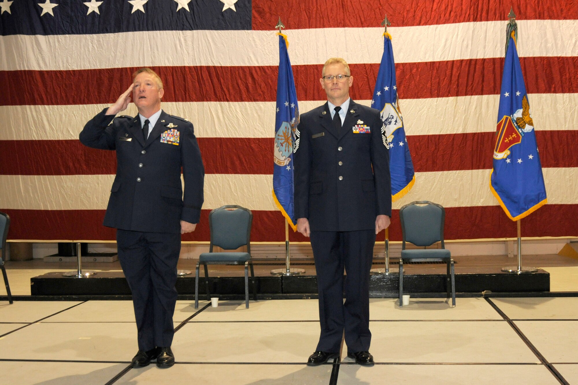 Col. Michael Thomas, 127th Wing commander, returns the salute of  the wing during a Dec. 4, 2011, commander's call and wing formation ceremony at Selfridge Air National Guard Base, Mich. The wing typically holds a ceremony toward the end of the year to recognize the achievements of the wing and its Airmen during the previous 12 months. With Col. Thomas is Chief Master Sgt. Bob Dobson, the 127th Wing command chief. (U.S. Air Force photo by TSgt. David Kujawa)