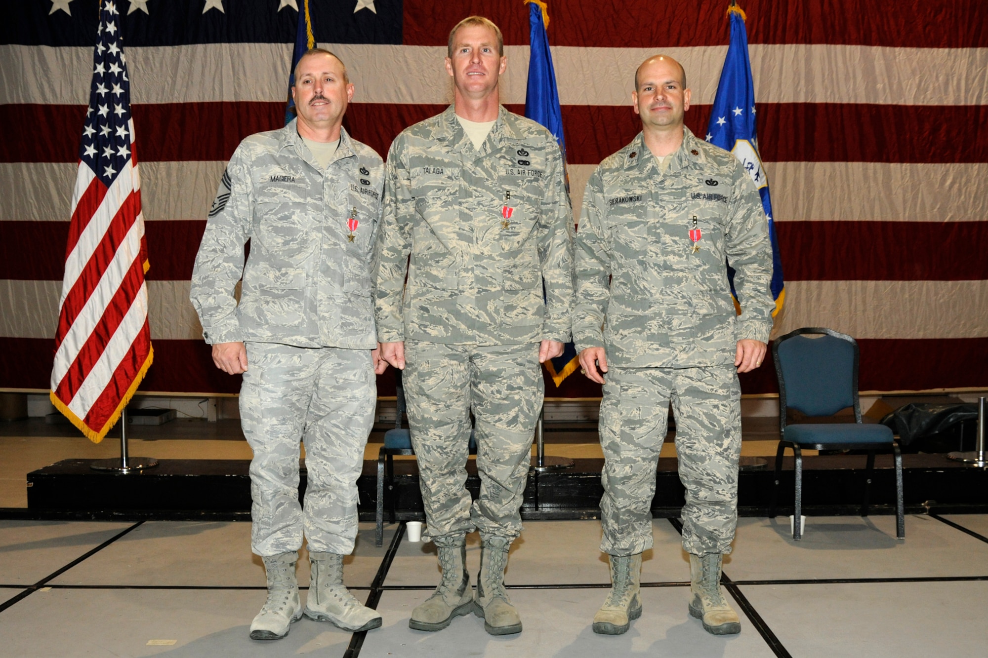 Chief Master Sgt. Matt Mageira, Senior Master Sgt. Jeff Talaga and Major Tom Sierkowski were awarded the Bronze Star Medal for their service in Afghanistan in 2011. The three Airmen, all assigned to the 127th Civil Engineering Squadron at Selfridge Air National Guard Base, Mich., served with a construction unit while forward deployed. During their deployment, the three Airmen served as leaders of the squadron, which was integrated with an Army engineering brigade. The Air Force squadron accomplished over 160 construction projects, worth more than $75 million. During their deployment, they and their squadron conducted numerous outside the wire missions and built the largest AM-2 MATT airfield in Air Force history, allowing for the completion of five named combat operations. The Airmen were awarded the medals at a Dec. 4, 2011, commanders call at Selfridge. (U.S. Air Force photo by TSgt. David Kujawa)