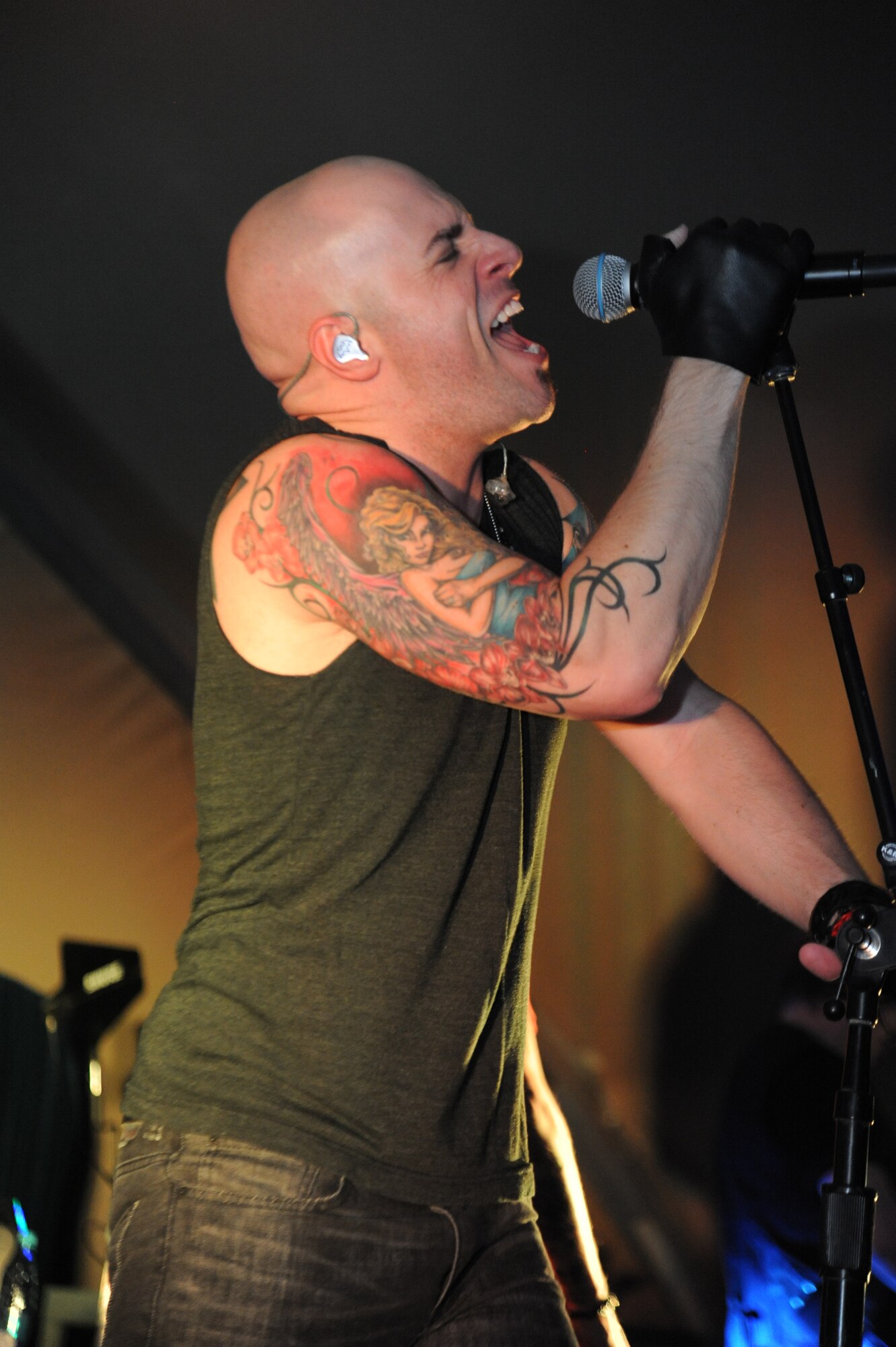 Chris Daughtry, lead singer for the band Daughtry, performs for service members during a concert at the Transit Center at Manas, Kyrgyzstan, Dec. 5. The band, comedian Gabriel Iglesias and members of the Band of the U.S. Air Force Reserve are on a 13-day tour playing six concerts that will take them through Southwest Asia and Europe to bring entertainment to American troops and their families as part of the Operation Seasons Greetings Tour for the Troops 2011. (U.S. Air Force photo/Tech. Sgt. Hank Hoegen)