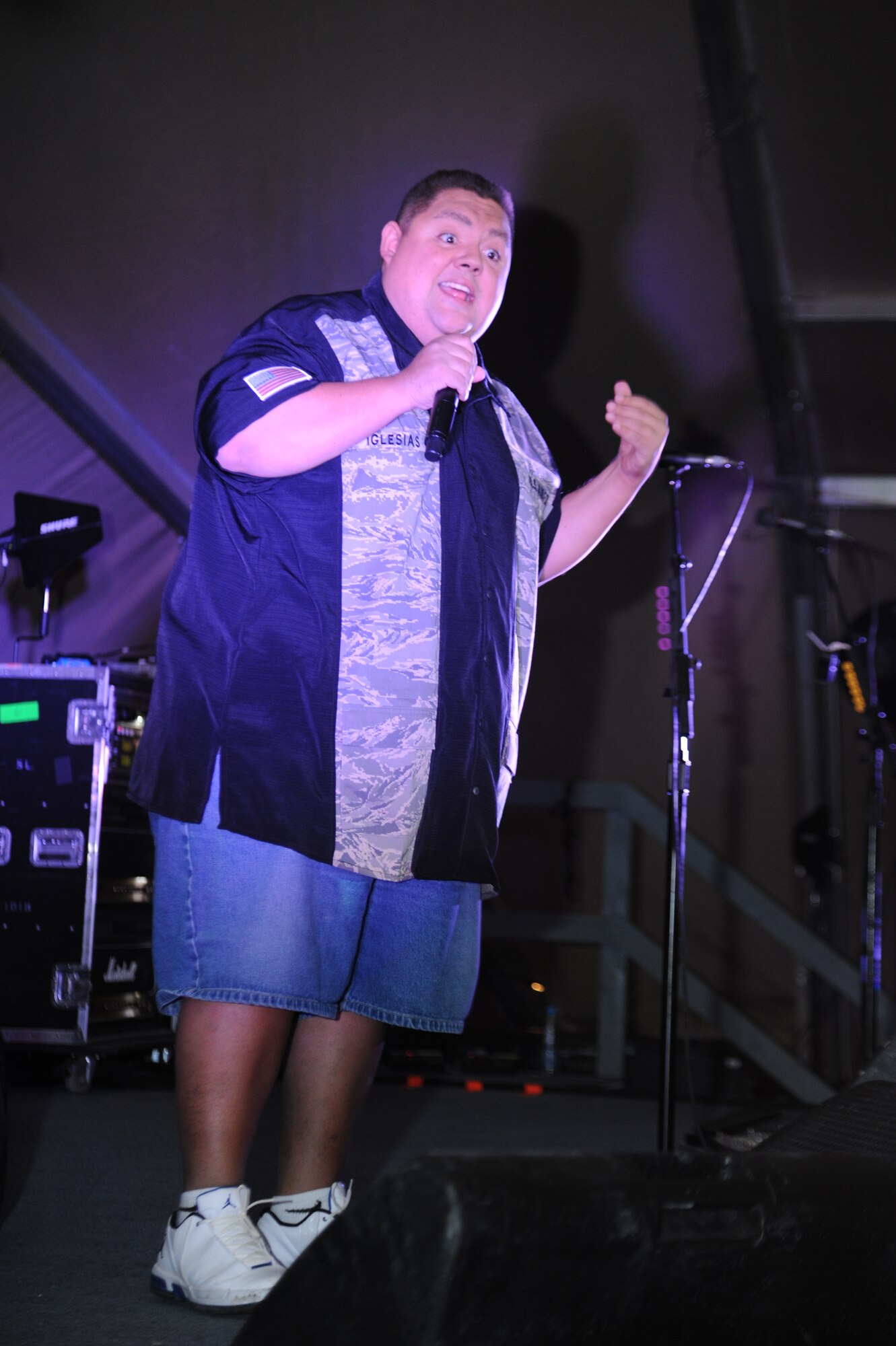 Comedian Gabriel Iglesias performs during a concert for service members at the Transit Center at Manas, Kyrgyzstan, Dec. 5. Iglesias, the rock band Daughtry and members of the Band of the U.S. Air Force Reserve are on a 13-day tour playing six concerts that will take them through Southwest Asia and Europe to bring entertainment to American troops and their families as part of the Operation Seasons Greetings Tour for the Troops 2011. (U.S. Air Force photo/Tech. Sgt. Hank Hoegen)