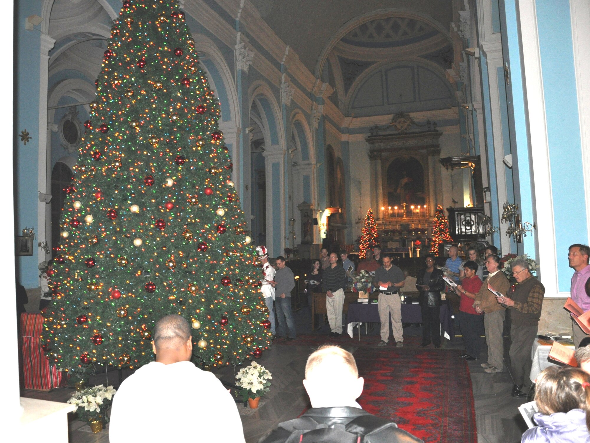 Members of NATO and the 425th Air Base Squadron attend the squadron's annual
Christmas tree lighting ceremony at the Izmir chapel Dec. 2, 2011, in Izmir,
Turkey. Izmir community members sang carols and celebrated with
refreshments. The three-story tall tree will stay lit during chapel services
throughout the holiday season. (U.S. Air Force photo by Tanju
Varlikli/Released)
