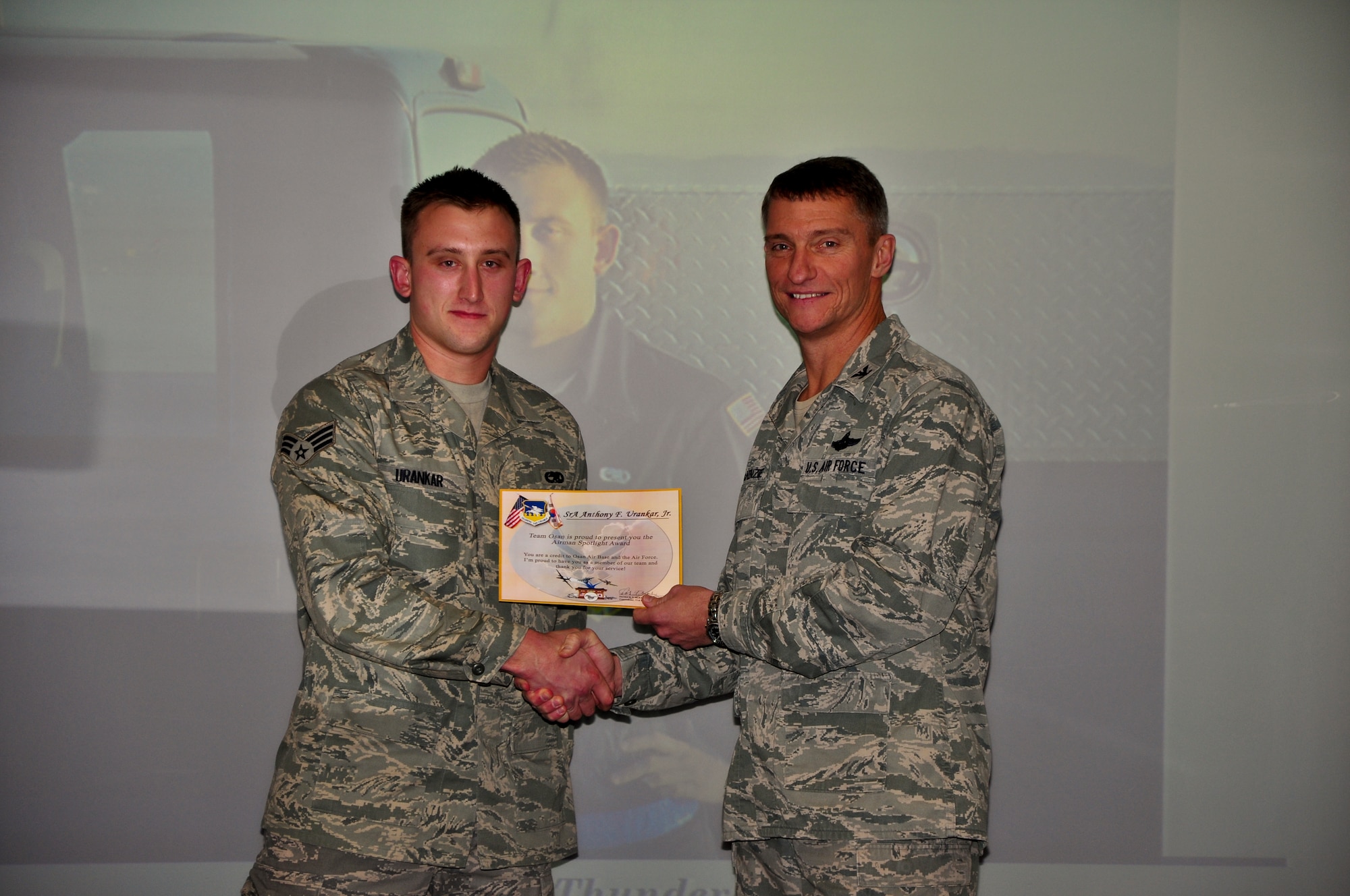 Senior Airman Anthony F. Urankar Jr., 51st Maintenance Squadron, recieves a an Airman Spotlight certificate from Col. Patrick McKenzie, 51st Fighter Wing commander, Dec. 6, 2011. (U.S. Air Force photo/Tech. Sgt. Chad Thompson)