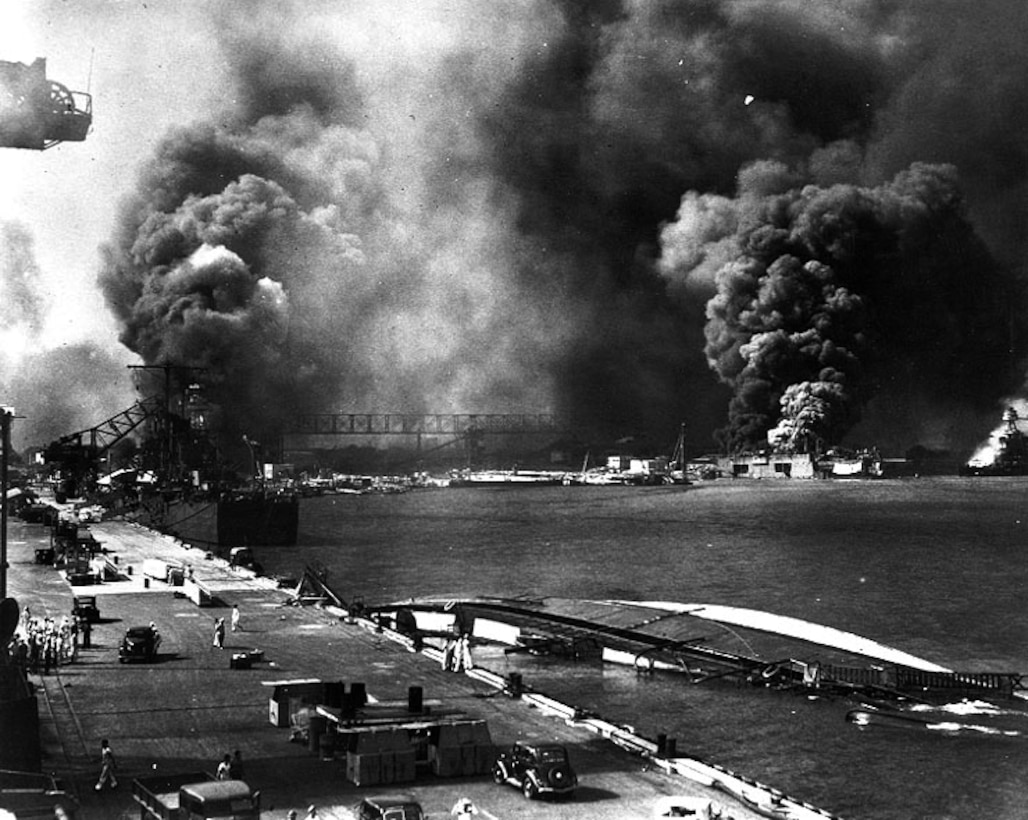 U.S. Navy ships burn after being bombed during the Japanese air attack in the Pearl Harbor Naval