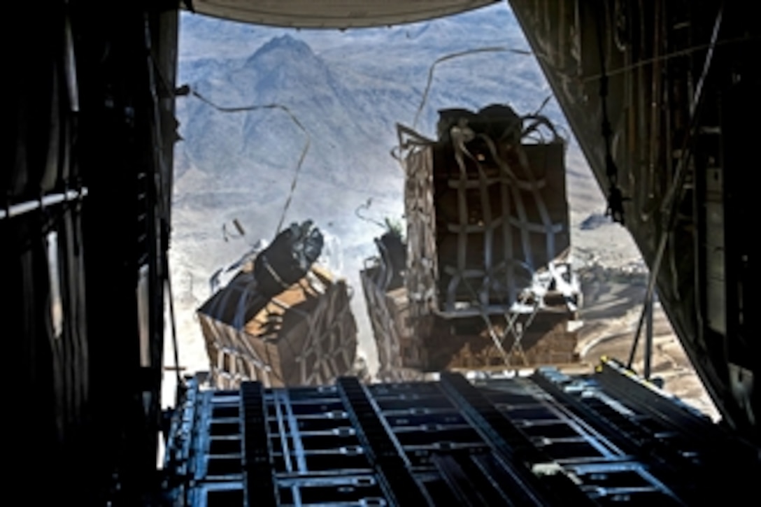 Crews drop pallets of food and supplies from a U.S. Air Force C-130 Hercules aircraft over Bagram Airfield in Kandahar, Afghanistan, on Nov. 23, 2011.  The C-130 crew is assigned to the 774th Expeditionary Airlift Squadron.  The supplies will go to soldiers at a remote base near Kandahar, Afghanistan.  