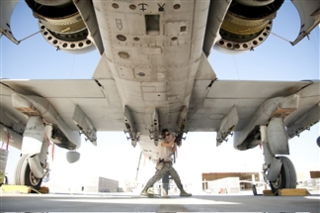 U.S. Air Force Senior Airman Steve Roeper, a weapons technician with the 107th Expeditionary Fighter Squadron, inspects and cleans a rack on an A-10 Thunderbolt aircraft at Kandahar Airfield in Kandahar province, Afghanistan, on Dec. 2, 2011.  An A-10 is capable of employing a wide variety of conventional ammunition, including general purpose bombs, cluster bomb units and laser guided bombs.  