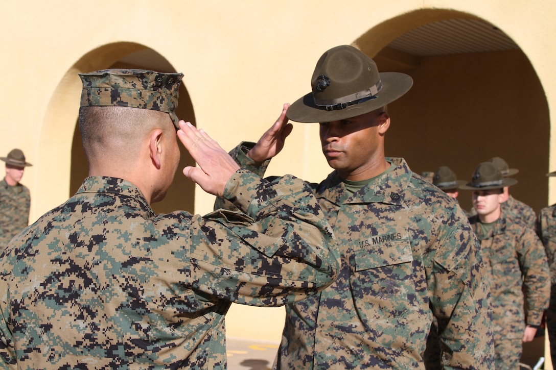 Gunnery Sgt. Jimmy Richard, drill master, 2nd Battalion is promoted by Brigadier General Daniel Yoo, commanding general, Marine Corps Recruit Depot San Diego at the yellow footprints Dec. 6. Richard was meritoriously promoted after winning the Commandant of the Marine Corps Drill Instructor of the Year award. Drill instructors from MCRD SD have won the award three consecutive years and currently has four past winners since 2000 serving on the depot.