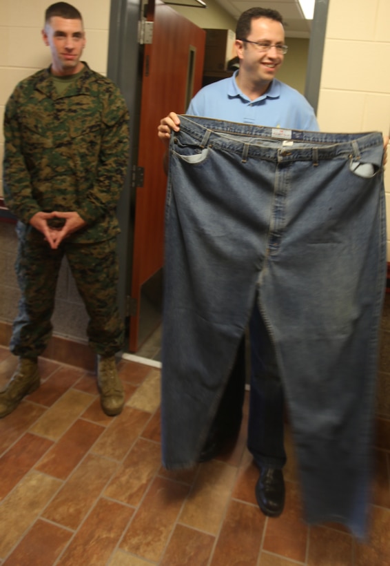 Jared Fogle, the spokesman for Subway restaurant, unveils jeans he wore while he weighed 425 lbs. to Marines at Wounded Warrior Battalion-East on Marine Corps Base Camp Lejeune Dec. 7.  Fogle also visited the Subway on base.(Official U.S. Marine Corps Photo by Pfc. Jackeline M. Perez Rivera)