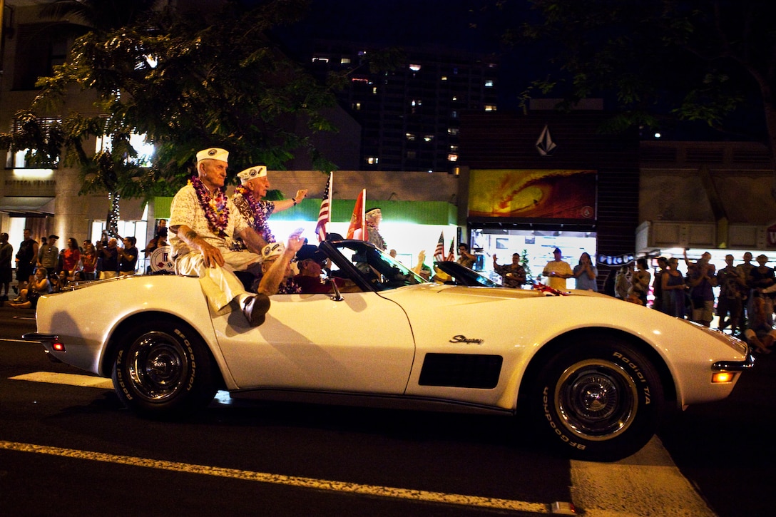 Pearl Harbor survivors wave from classic cars to a cheering crowd during the first ever Pearl Harbor Memorial Parade in Honolulu on Dec. 7. The survivors had also been recognized at the 70th Annual Pearl Harbor Day  Commemoration that morning.