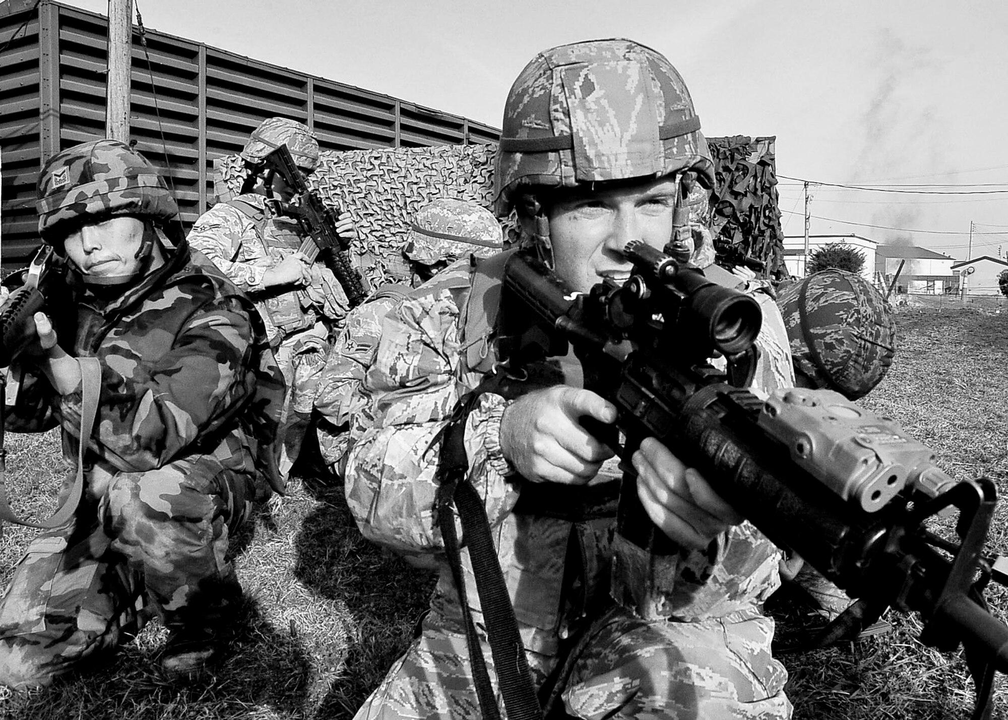 Members of a firing squad perform 360 security during the confidence course portion of the Combat Readiness Course Dec. 05, 2011. The confidence course is an obstacle course that tests the participant’s abilities to survive as a team while communicating when placed in stressful situations. (U.S. Air Force photo/Senior Airman Adam Grant)