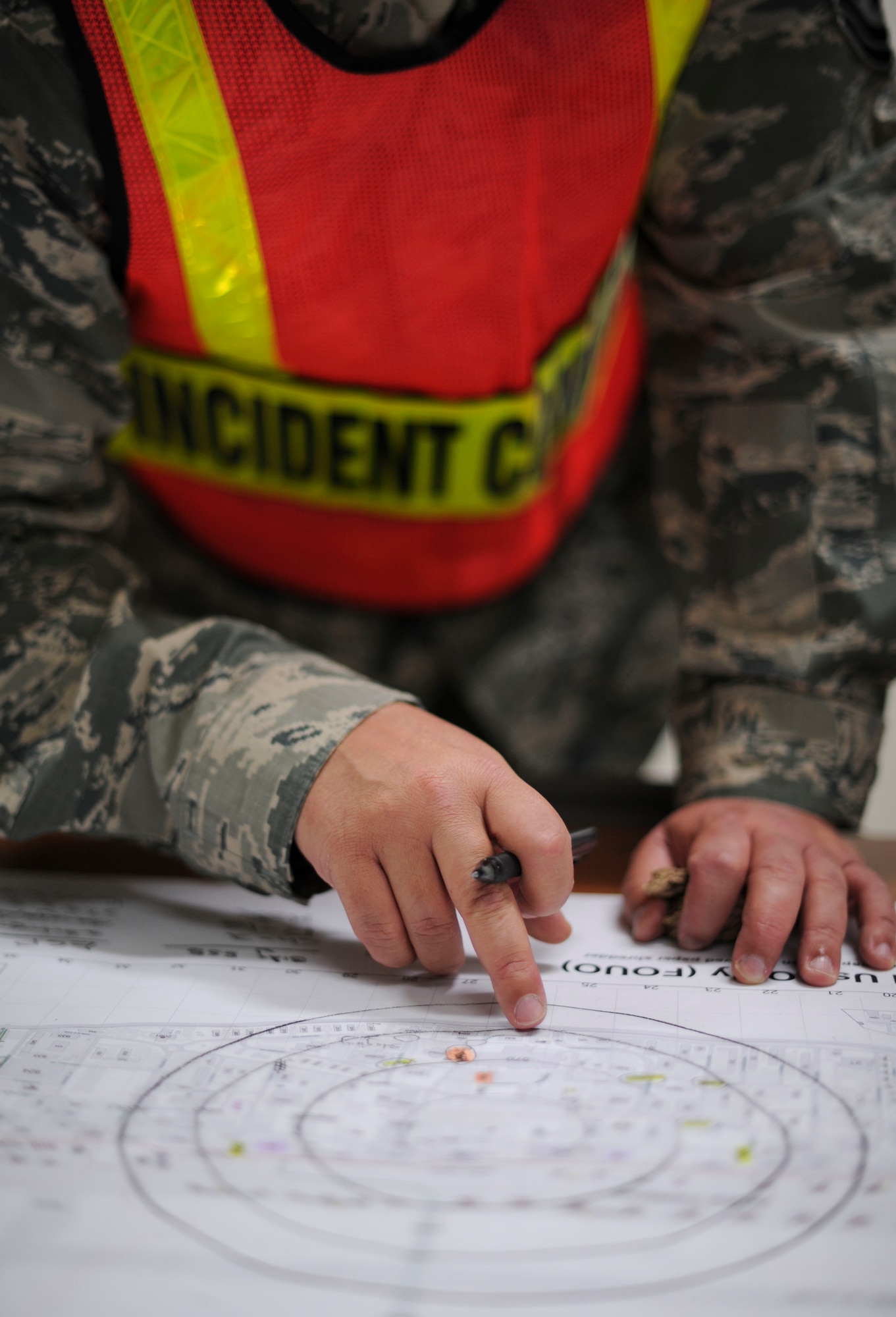 YOKOTA AIR BASE, Japan ? Master Sgt. James Beasly, 374th Civil Engineering Squadron and on-scene incident commander, looks at a base map determining building evacuations within a 1,500 foot cordon at Yokota Air Base, 7 Dec. 2011.  The cordon was established in preparation of a controlled detonation due to an unexploded ordnance discovered near the fitness center 6 Dec. 2011.(U.S. Air Force Photo by/ Staff Sgt. Stacy Moless)