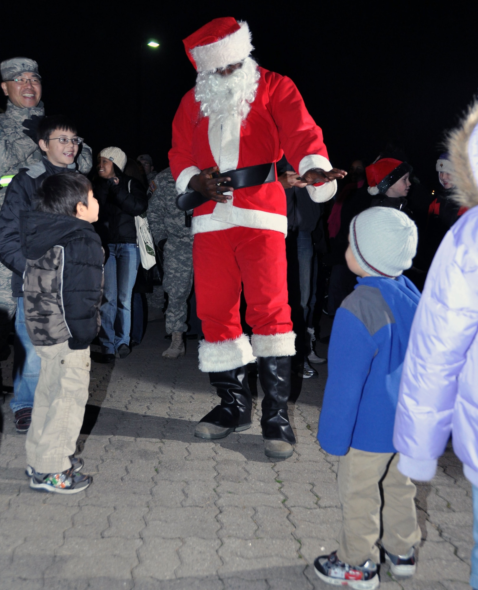 Santa Clause greets children as he arrives during the base tree lighting ceremony Dec. 7, 2011. (U.S. Air Force photo/Airman 1st Class Michael Battles)