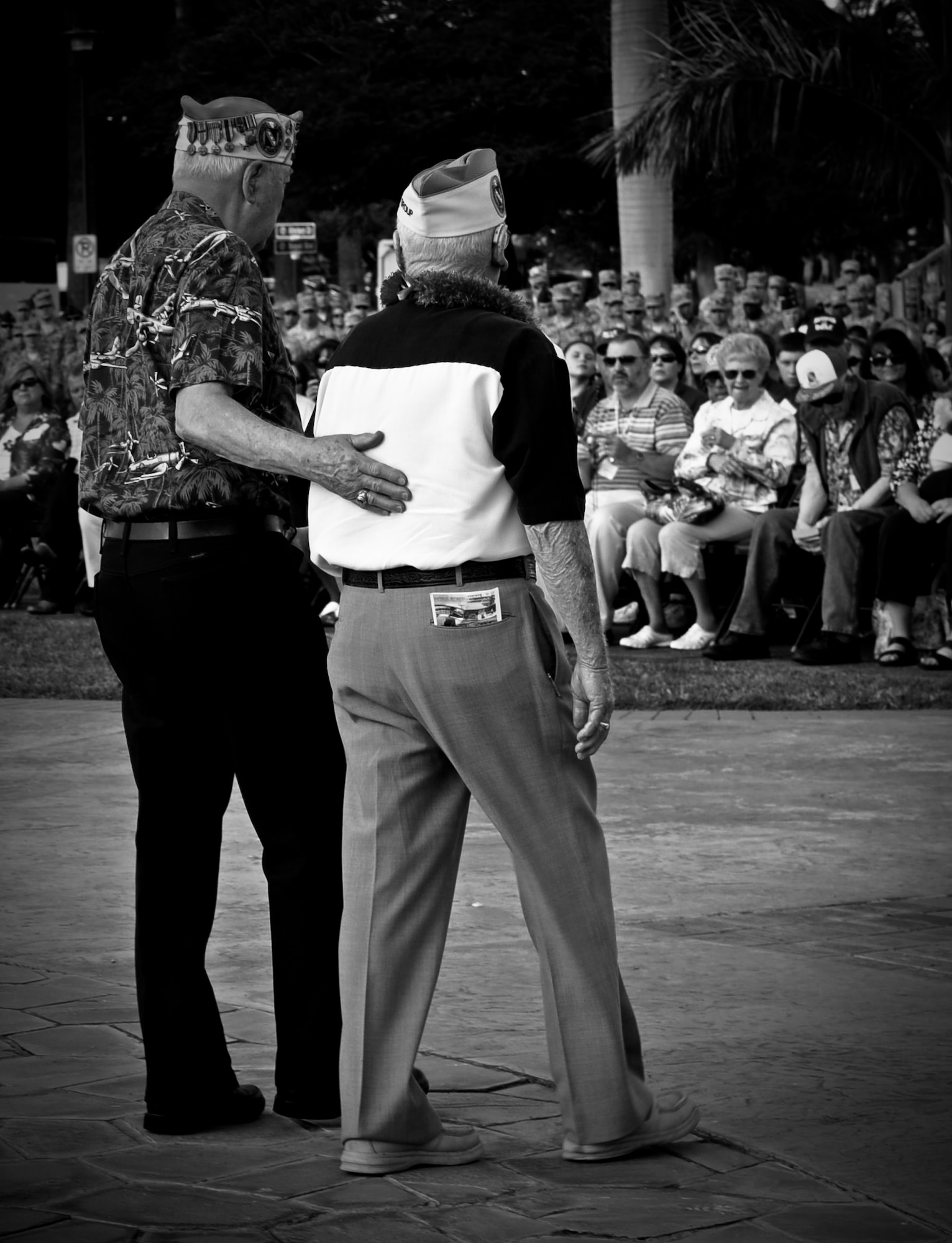 Members of the 11th Bomb Group return to their seats after placing a wreath at the base of the flag pole during a 70th Anniversary Remembrance Ceremony at Atterbury Circle on Joint Base Pearl Harbor-Hickam, Hawaii, Dec. 7, 2011. During the attacks on Hickam, 189 Army Air Corps Airmen and civilians lost their lives. (U.S. Air Force photo/Senior Airman Lauren Main)