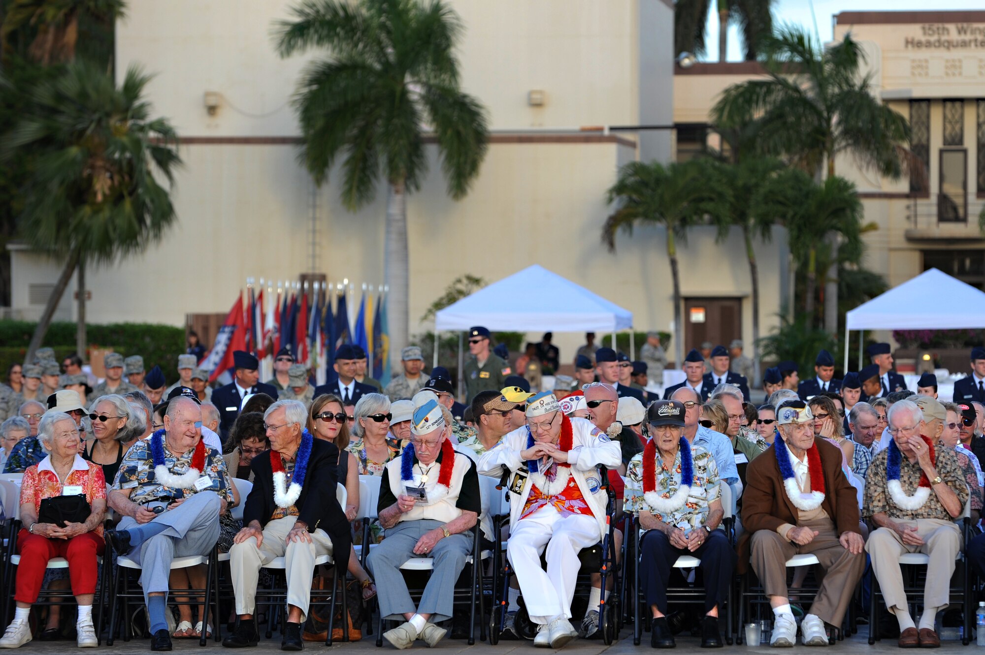 Hickam Field survivors of the attacks on Dec. 7, 1941, line the front row and are surrounded by Airmen, civilians and their families at Atterbury Circle during the 70th Anniversary Remembrance Ceremony on Joint Base Pearl Harbor-Hickam, Hawaii, Dec. 7, 2011. During the attacks, 189 Army Air Corps Airmen and civilians lost their lives and 303 were wounded. (U.S. Air Force photo/Staff Sgt. Mike Meares)
