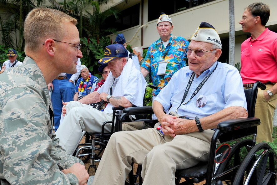 Brig. Gen. Mark M. McLeod, Pacific Air Forces director of logistics, meets with a Pearl Harbor survivor in the Courtyard of Heroes located at the PACAF Headquarters building, Joint Base Pearl Harbor-Hickam, Hawaii, Dec. 6, 2011. Some of the survivors from the attack were present to attend the 70th Anniversary Commemorative Ceremony, hosted by the 15th Wing at the joint base. (U.S. Air Force photo/Tech. Sgt. Jerome S. Tayborn/Released)
