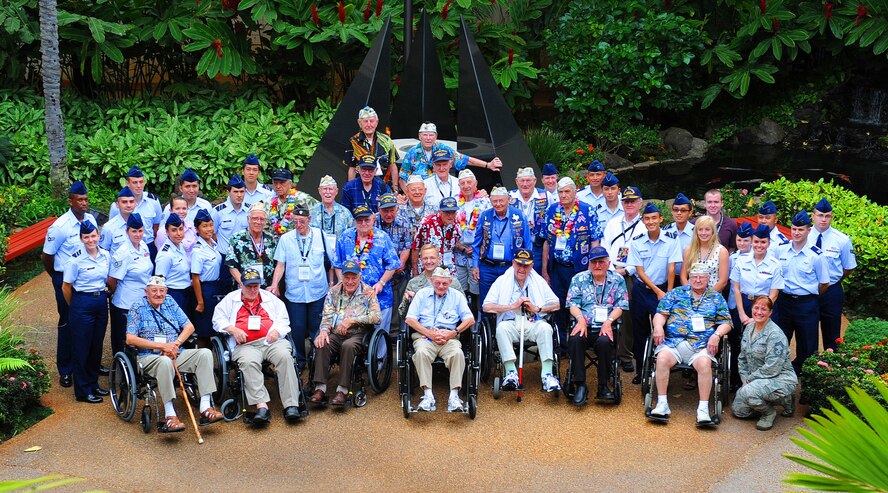 Brig. Gen. Mark M. McLeod, Pacific Air Forces director of logistics, PACAF staff members and U.S. Air Force cadets pose for a group photo with Pearl Harbor survivors in the Courtyard of Heroes located at the PACAF Headquarters building, Joint Base Pearl Harbor-Hickam, Hawaii, Dec. 6, 2011. Some of the survivors from the attack were present to attend the 70th Anniversary Commemorative Ceremony, hosted by the 15th Wing at the joint base. (U.S. Air Force photo/Tech. Sgt. Jerome S. Tayborn/Released)