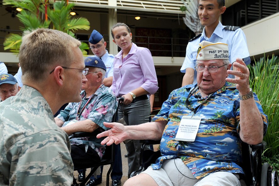 Brig. Gen. Mark M. McLeod, Pacific Air Forces director of logistics, meets with a Pearl Harbor survivor in the Courtyard of Heroes located at the PACAF Headquarters building, Joint Base Pearl Harbor-Hickam, Hawaii, Dec. 6, 2011. Some of the survivors from the attack were present to attend the 70th Anniversary Commemorative Ceremony, hosted by the 15th Wing at the joint base. (U.S. Air Force photo/Tech. Sgt. Jerome S. Tayborn/Released)