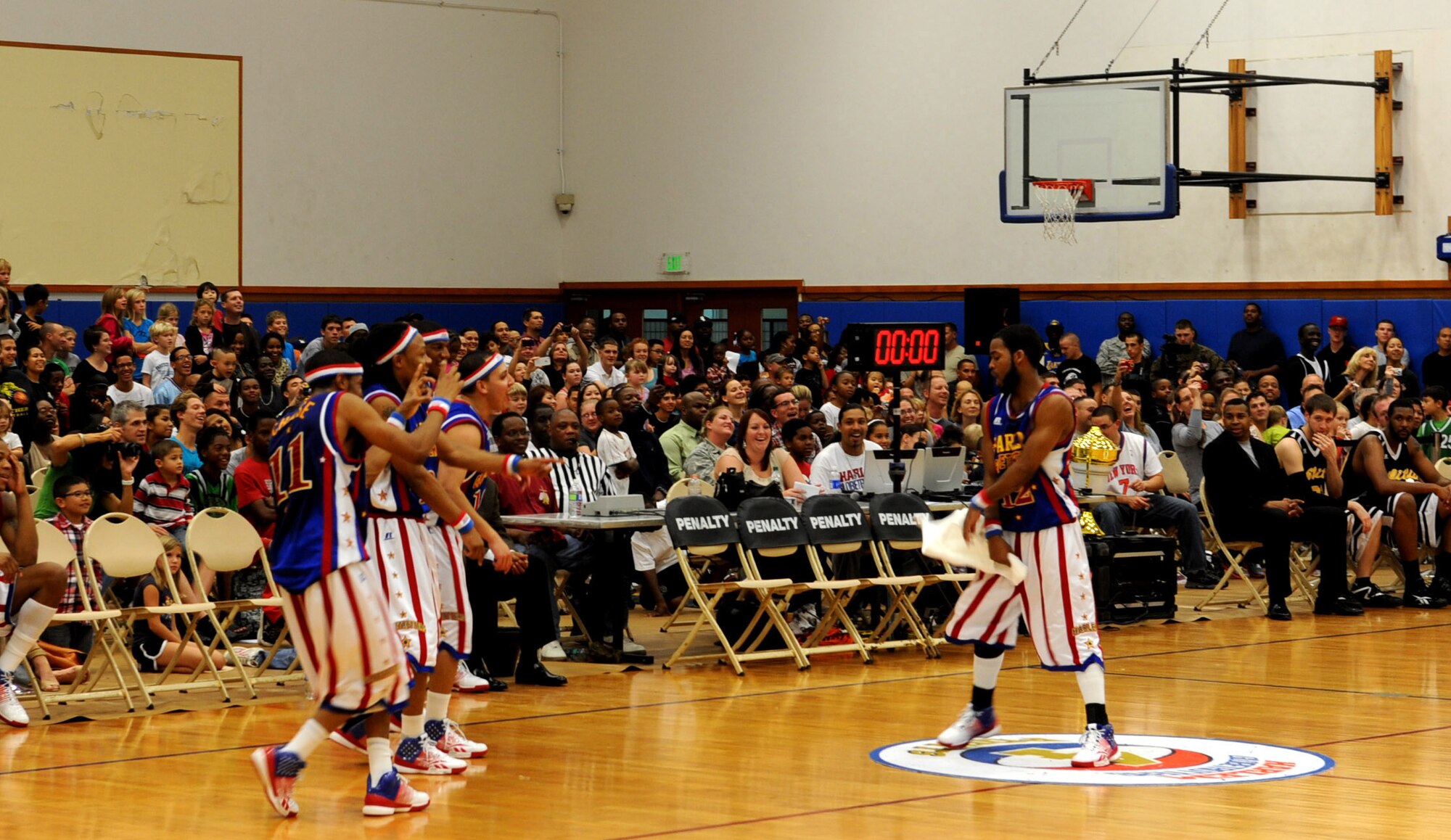 Ant, of the world-famous Harlem Globetrotters, does the Dougie during the basketball game at the Risner gymnasium, on Kadena Air Base, Japan, Dec. 6, 2011. The Dougie is a hip-hop dance generally performed by moving one's body in a shimmy style and passing a hand through or near the hair on one's own head. (U.S. Air Force photo by Airman 1st Class Justin Veazie/Released)