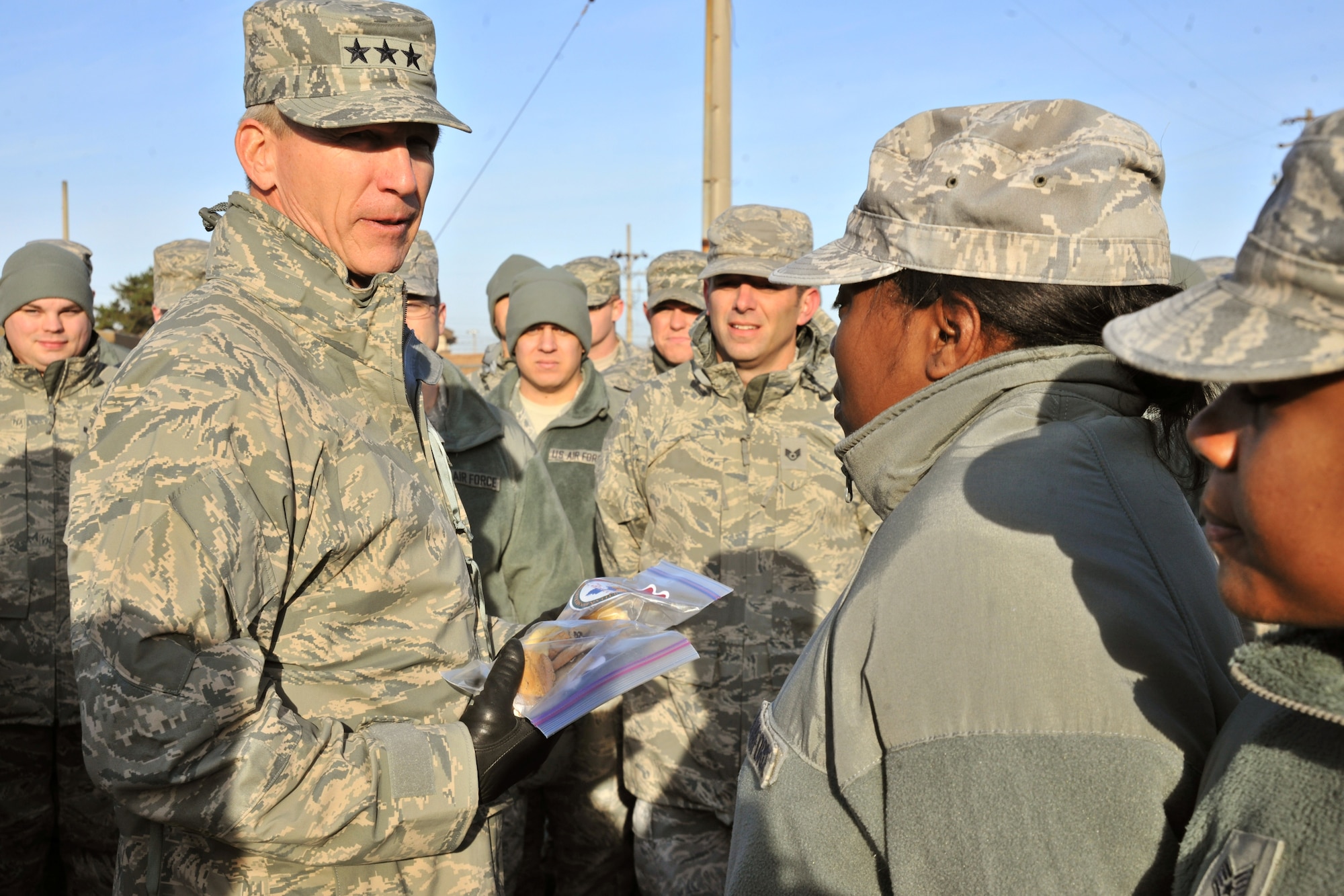 Lt. Gen. Jeffery Remington, 7th Air Force and Air Forces Korea commander, visits Airmen from the 8th Mission Support Group at Kunsan Air Base, Republic of Korea, Dec. 5, 2011. Remington handed out Christmas cards and cookies to Airmen during his visit. (U.S. Air Force photo by Senior Airman Brittany Y. Auld/Released)
