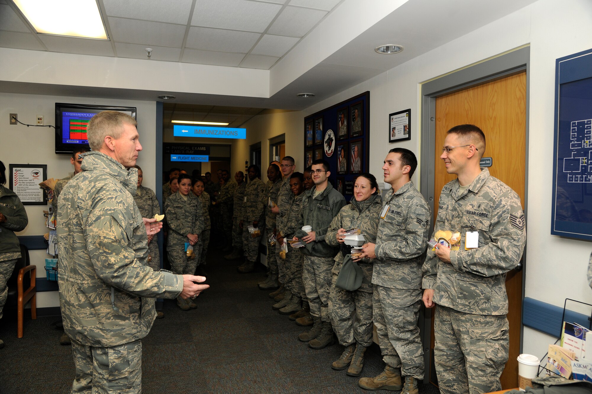 Lt. Gen. Jeffrey A. Remington, 7th Air Force and Air Forces Korea commander, passes out Christmas cards and cookies to Airmen from the 8th Medical Group at Kunsan Air Base, Republic of Korea, Dec. 6, 2011. Remington visited Kunsan AB and other bases to distribute 80,000 cookies to Airmen serving in Korea. The cookies were made by a spouses group at Osan Air Base. (U.S. Air Force photo by Staff Sgt. Rasheen Douglas/Released)