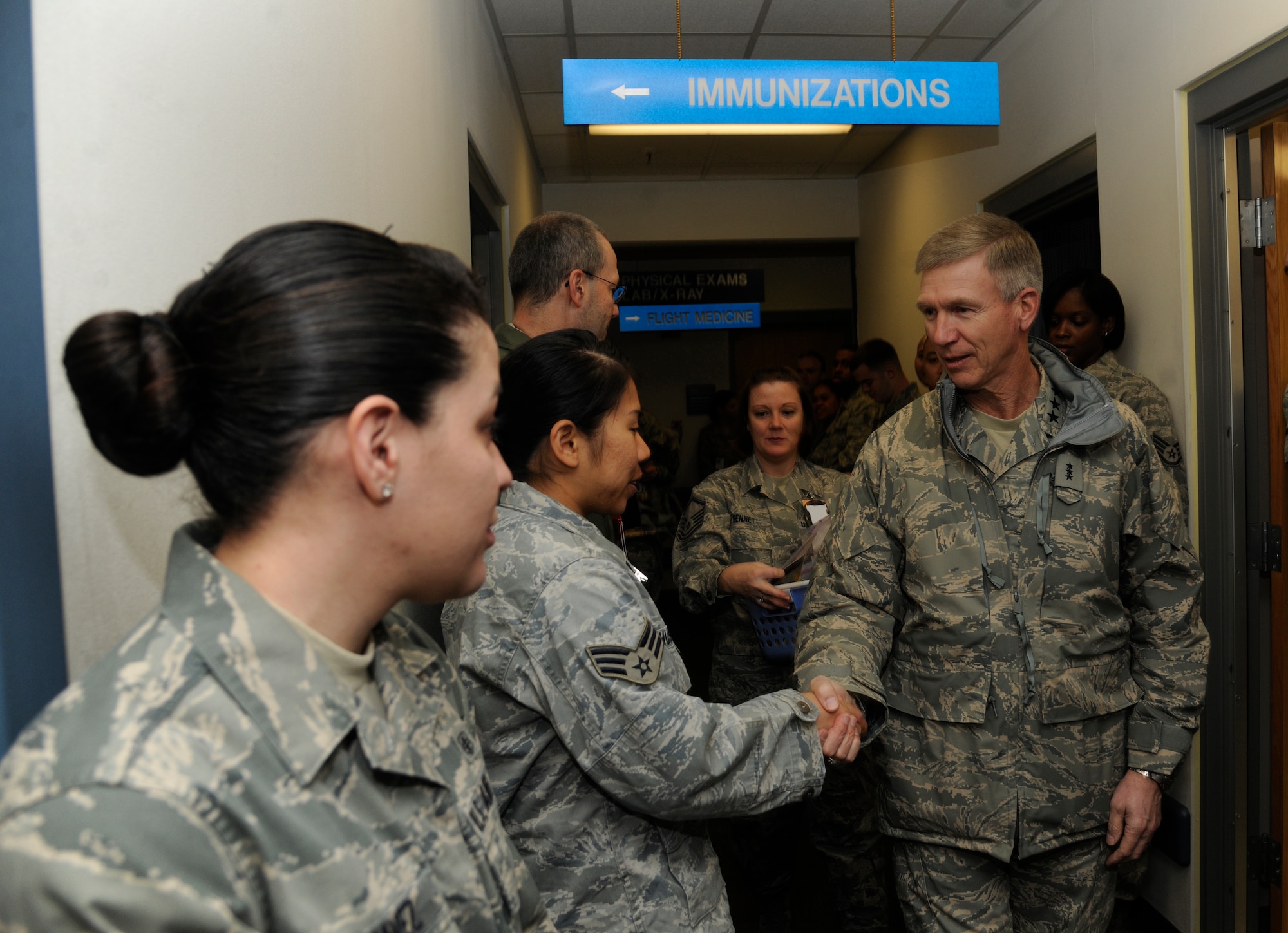 Lt. Gen. Jeffrey A. Remington, 7th Air Force and Air Forces Korea commander, passes out Christmas cards and cookies to Airmen from the 8th Medical Group at Kunsan Air Base, Republic of Korea, Dec. 6, 2011. Remington visited Kunsan AB and other bases to distribute 80,000 cookies to Airmen serving in Korea. The cookies were made by a spouses group at Osan Air Base. (U.S. Air Force photo by Staff Sgt. Rasheen Douglas/Released)