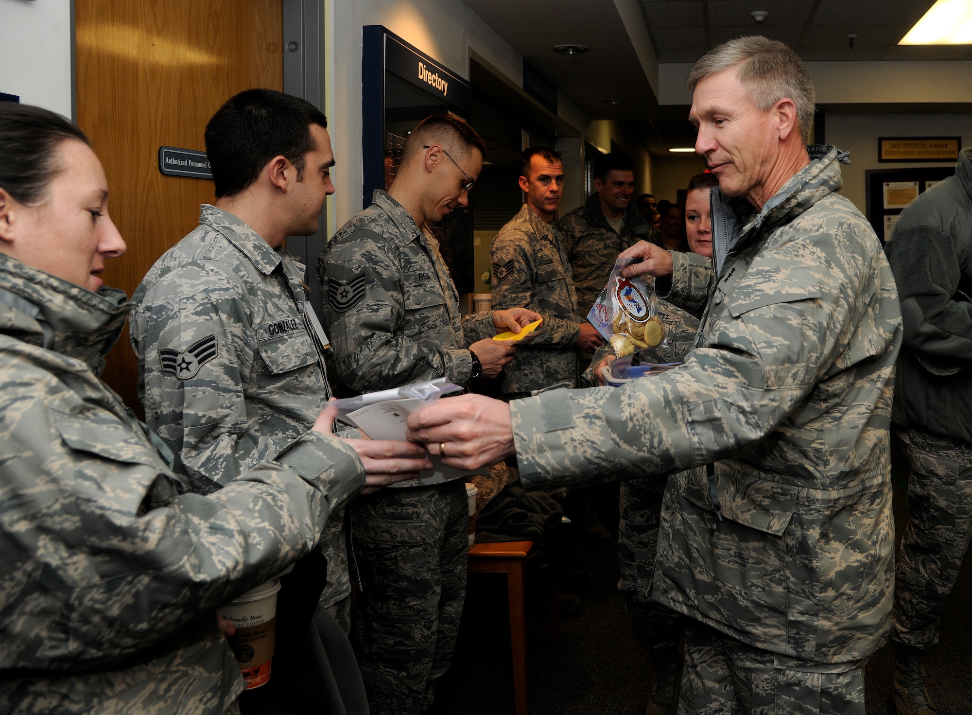 Lt. Gen. Jeffrey A. Remington, 7th Air Force and Air Forces Korea commander, passes out Christmas cards and cookies to Airmen from the 8th Medical Group at Kunsan Air Base, Republic of Korea, Dec. 6, 2011. Remington visited Kunsan AB and other bases to distribute 80,000 cookies to Airmen serving in Korea. The cookies were made by a spouses group at Osan Air Base. (U.S. Air Force photo by Staff Sgt. Rasheen Douglas/Released)