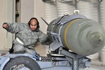 Staff Sgt. Anthony Castillo, 8th Aircraft Maintenance Squadron weapons load crew member, downloads a weapon from an F-16 Fighting Falcon after an elephant walk formation at Kunsan Air Base, Republic of Korea, Dec. 2, 2011. The exercise showcased Kunsan AB aircrews' capability to quickly and safely prepare an aircraft for a wartime mission. (U.S. Air Force photo by Senior Airman Brittany Y. Auld/Released)