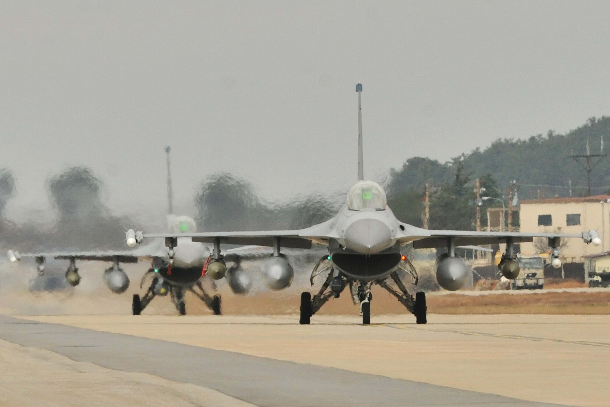 F-16 Fighting Falcons from both the 35th and 80th Fighter Squadrons of the 8th Fighter Wing, as well as from the 466th Fighter Squadron of the 419th Fighter Wing at Hill Air Force Base, Utah, demonstrate an elephant walk formation as they taxi down a runway during an exercise at Kunsan Air Base, Republic of Korea Dec. 2, 2011. The exercise showcased Kunsan AB aircrews' capability to quickly and safely prepare an aircraft for a wartime mission.  (U.S. Air Force photo by Senior Airman Brittany Y. Auld/Released)