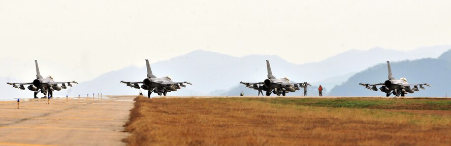 F-16 Fighting Falcons from both the 35th and 80th Fighter Squadrons of the 8th Fighter Wing, as well as from the 466th Fighter Squadron of the 419th Fighter Wing at Hill Air Force Base, Utah, demonstrate an elephant walk formation as they taxi down a runway during an exercise at Kunsan Air Base, Republic of Korea Dec. 2, 2011. The exercise showcased Kunsan AB aircrews' capability to quickly and safely prepare an aircraft for a wartime mission.  (U.S. Air Force photo by Senior Airman Brittany Y. Auld/Released)