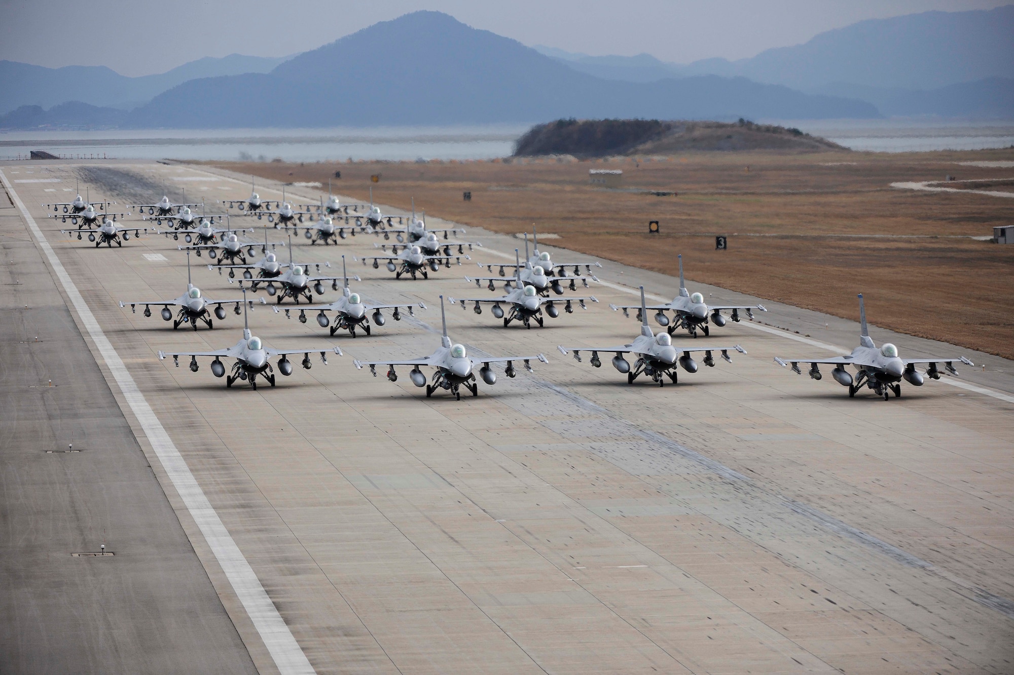 F-16 Fighting Falcons from both the 35th and 80th Fighter Squadrons of the 8th Fighter Wing, as well as from the 466th Fighter Squadron of the 419th Fighter Wing at Hill Air Force Base, Utah, demonstrate an elephant walk formation as they taxi down a runway during an exercise at Kunsan Air Base, Republic of Korea Dec. 2, 2011. The exercise showcased Kunsan AB aircrews' capability to quickly and safely prepare an aircraft for a wartime mission.  (U.S. Air Force photo by Staff Sgt. Rasheen Douglas/Released)