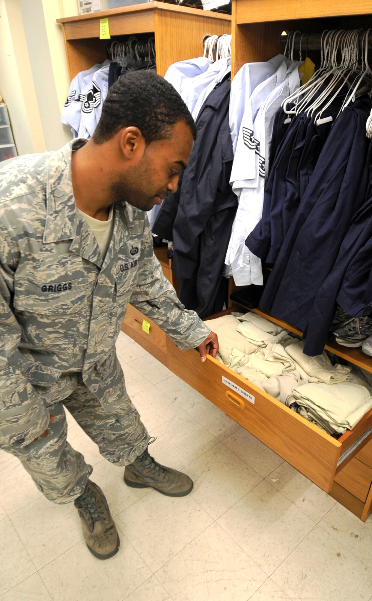 Tech. Sgt. Carlos Griggs, 8th Force Support Squadron manpower analyst, opens a drawer full of airman battle uniform t-shirts available to Airmen at Kunsan Air Base, Republic of Korea, Nov. 30, 2011. The attic offers an array of uniform items, which were donated and are available free of charge for servicemembers. The attic is open Wednesdays and Thursdays 11 a.m. to 3 p.m. and Saturdays and Sundays 11 a.m. to 3 p.m. (U.S. Air Force photo by Senior Airman Jessica Hines/Released)