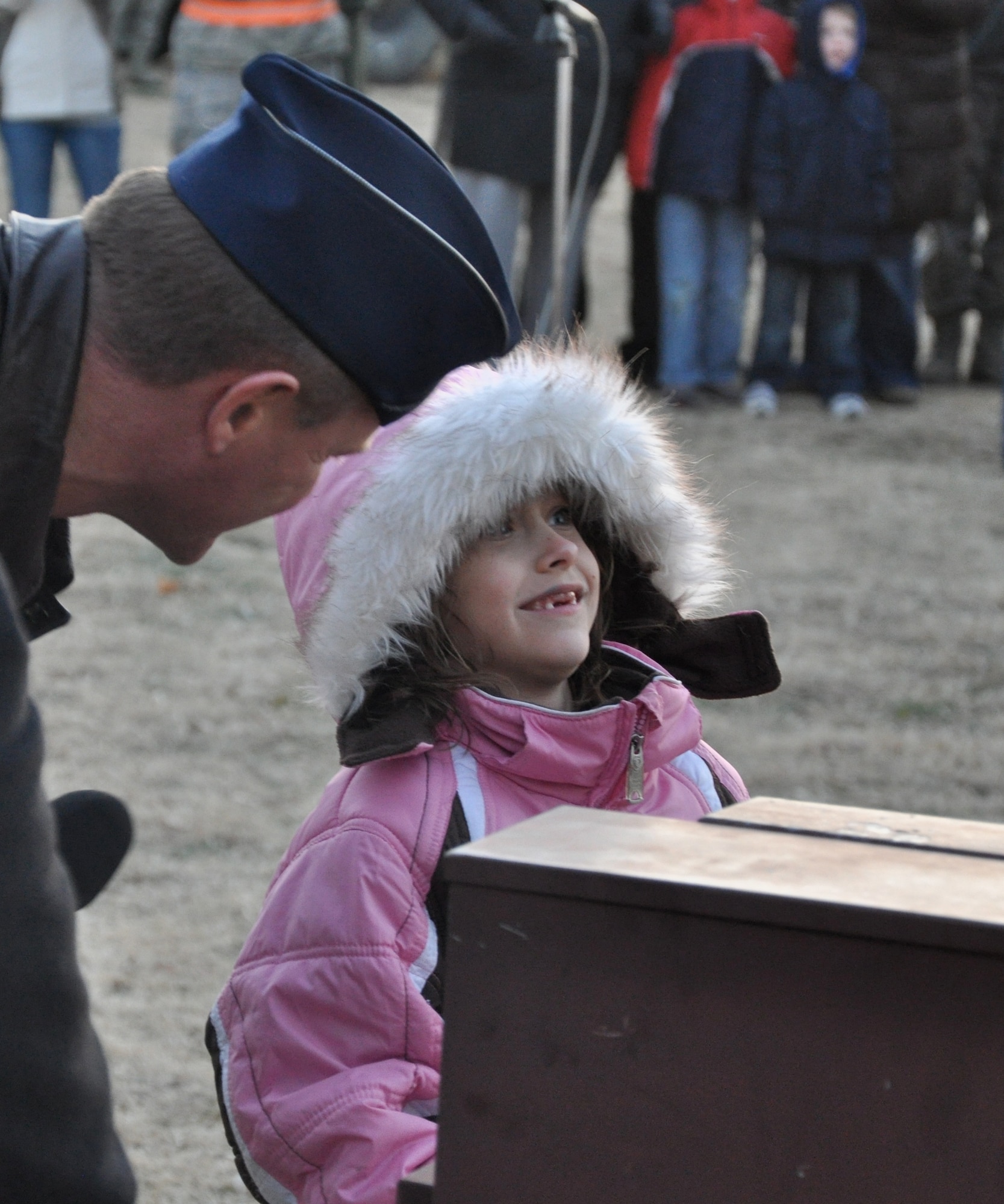 Kimberly Boles, a second grader at Eisenhower Elementary School, with the help of Col. Russ Mack, the 71st Flying Training Wing commander, flips the switch to light up the Wing Tree with during a ceremony Dec. 2 at Vance Air Force Base, Okla. More than 235 attended the ceremony. The Team Vance members and their families consumed 200 cookies and 18 gallons of hot chocolate. Displays of Air Force equipment and Army vehicles from the 401st Army Engineer Company were set up for the attendees to view. Kimberly is the daughter of Tech. Sgt. Kyle Boles with the 71st Flying Training Wing Safety Office. (U.S. Air Force photo/ Airman 1st Class Frank John Casciotta)