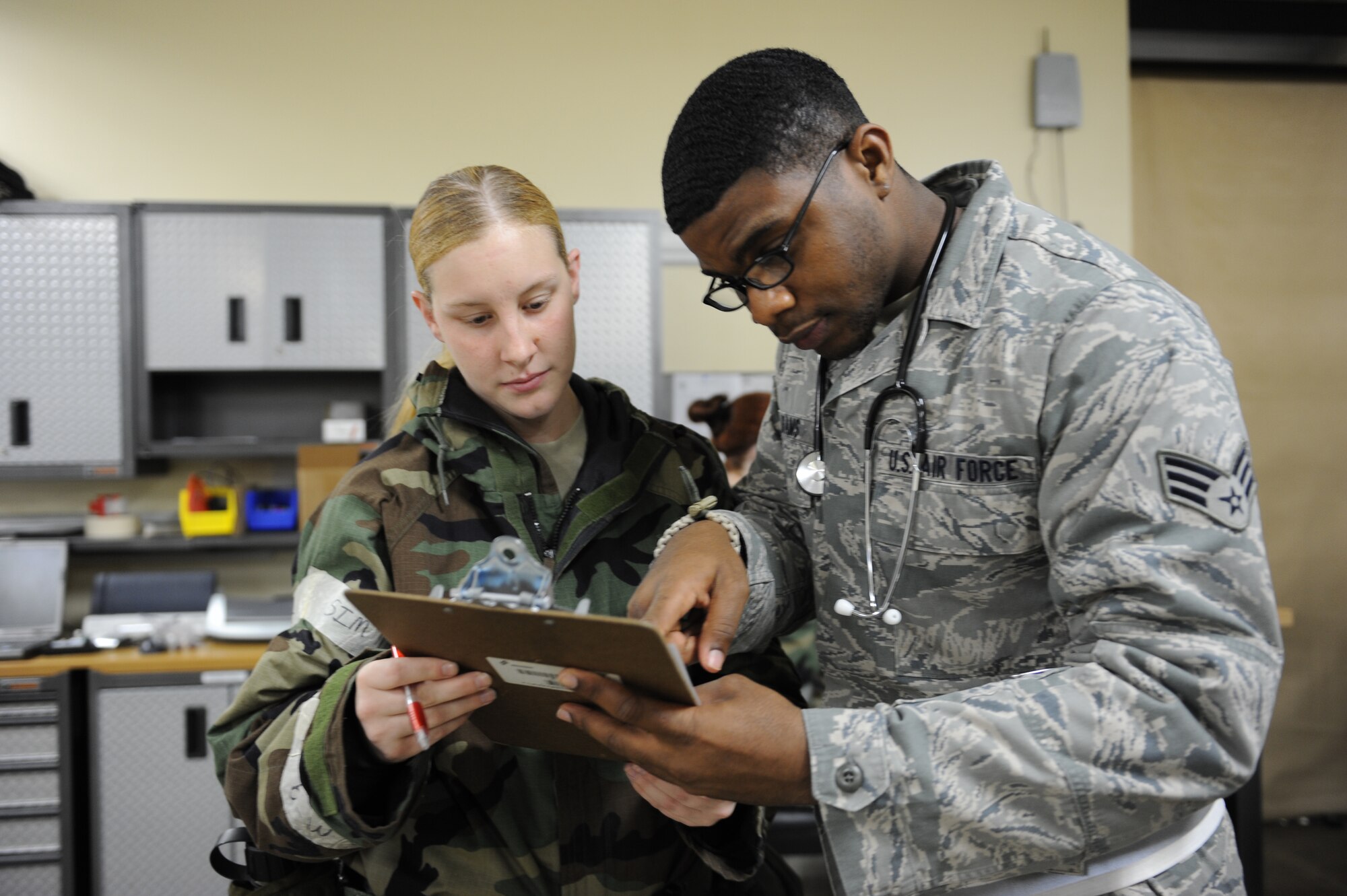 MISAWA AIR BASE, Japan - Senior Airman Jordan Atkins, left, 35th Medical Support Squadron, and Senior Airman Jeremy Adams, 35th Medical Operations Squadron, review patient records during an operational readiness inspection here Dec. 7. Pacific Air Forces Inspector General is inspecting the war fighting capability of Misawa's airmen. (U.S. Air Force photo/Airman 1st Class Kia Atkins)