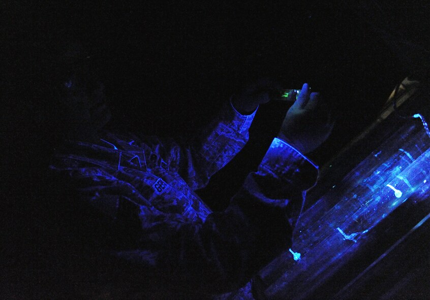 WHITEMAN AIR FORCE BASE, Mo. -- Senior Airman Brandon Gerst looks for surface defects under a black light Dec. 2, 2011. The black light causes particles, which are unseen to the human eye, to become florescent. Gerst is a non-destructive inspection technician assigned to the 509th Maintenance Squadron. (U.S. Air Force photo by Senior Airman Laura Goodgame) 
