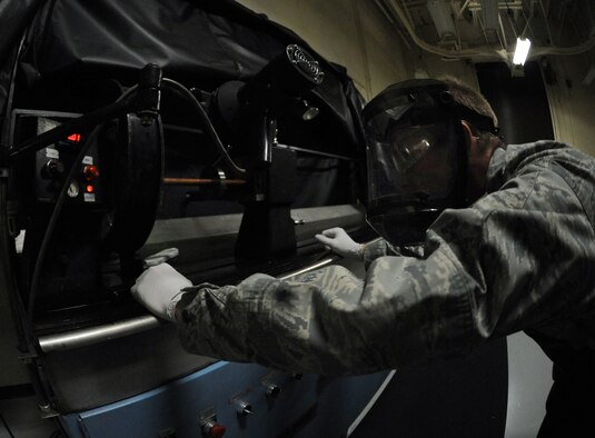 WHITEMAN AIR FORCE BASE, Mo. -- Senior Airman Brandon Gerst checks the current flowing through the magnetic particle testing machine Dec. 2, 2011. The machine provides the ability to detect surface and slight subsurface discontinuities not seen by the human eye on aircraft mechanical parts. Gerst is a non-destructive inspection technician assigned to the 509th Maintenance Squadron. (U.S. Air Force photo by Senior Airman Laura Goodgame) 