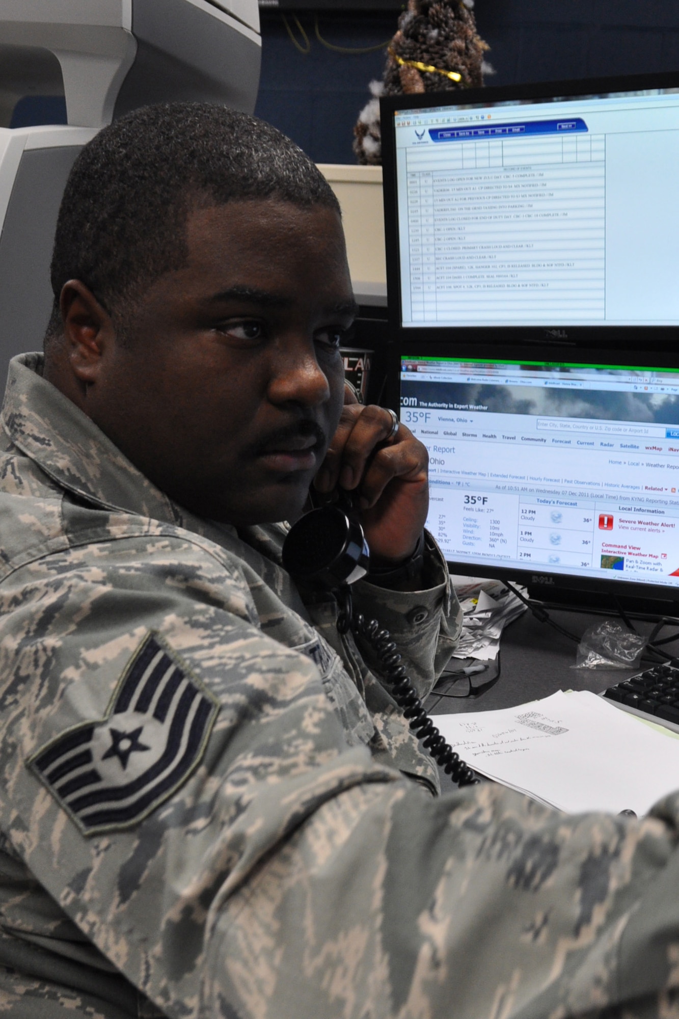 YOUNGSTOWN AIR RESERVE STATION, Ohio — Air Force Reserve Tech. Sgt. Keith Traylor, a Command Post (CP) controller with the 910th Airlift Wing, coordinates receipt of a mock press release to relay to wing leadership during a regularly scheduled exercise here, Dec. 6, 2011. CP controllers disseminate focused, accurate and often time-critical information throughout the wing’s chain of command.  Some of their everyday tasks include orchestrating maintenance, passenger, cargo and logistics requirements for the 910th Airlift Wing’s C-130H cargo aircraft. Additionally, the controllers are responsible for producing reports to the wing's higher headquarters, keeping them informed of significant installation incidents, emergencies and capabilities. U.S. Air Force Photo by Maj. Brent J. Davis. 
