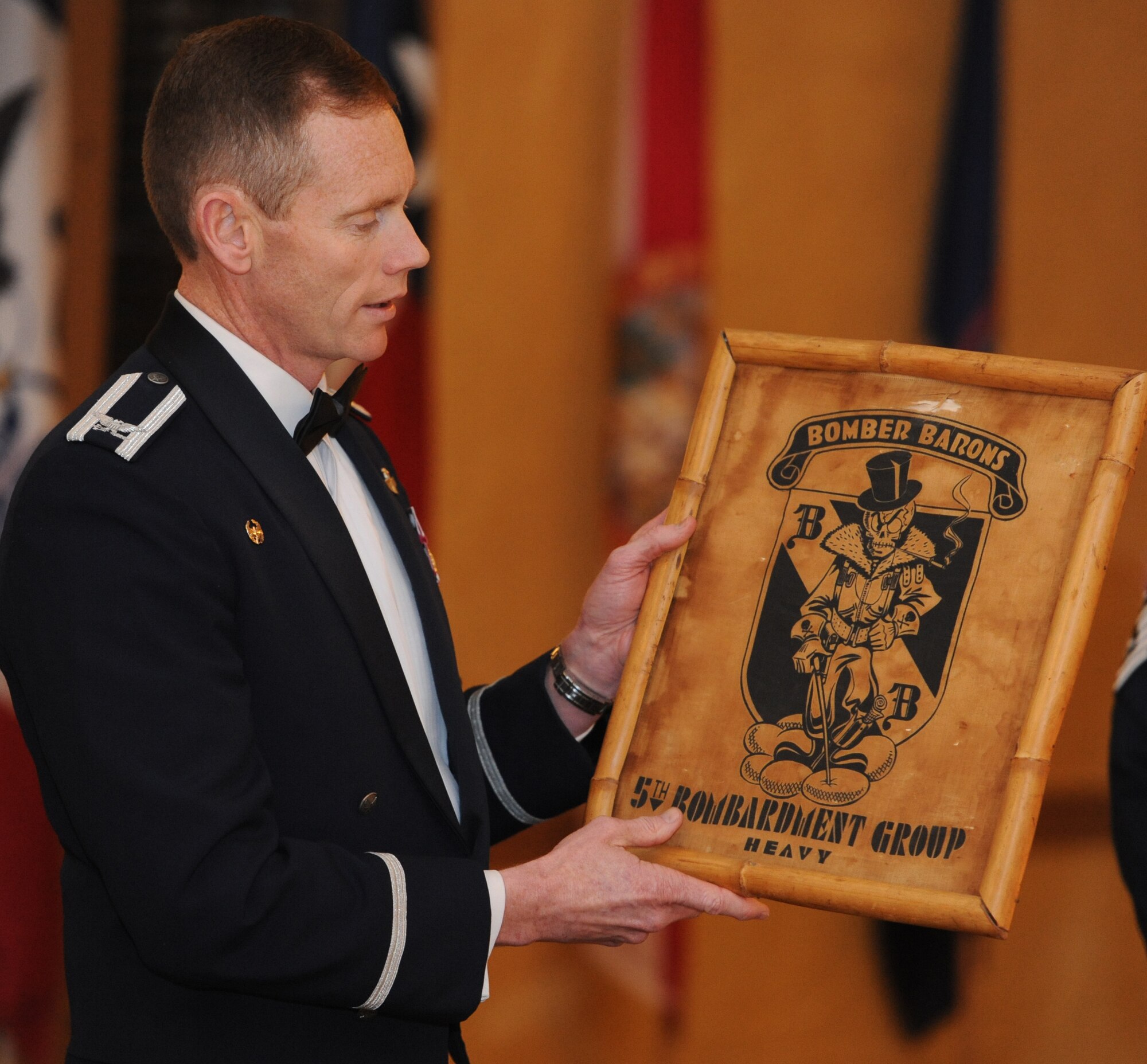 BARKSDALE AIR FORCE BASE, La. - Colonel James C. Dawkins, 5th Bomb Wing commander, explains his wing's history dating back to the 5th Bombardment Group in 1922 during the inaugural Air Force Global Strike Command Heritage Dinner to foster pride in our nuclear heritage and mission. Wing and numbered Air Force commanders and command chief master sergeants met at Barksdale Air Force Base for a commander's conference, and for the dinner, brought historical artifacts to represent their organizations. (U.S. Air Force photo by Master Sgt. Corey A. Clements)