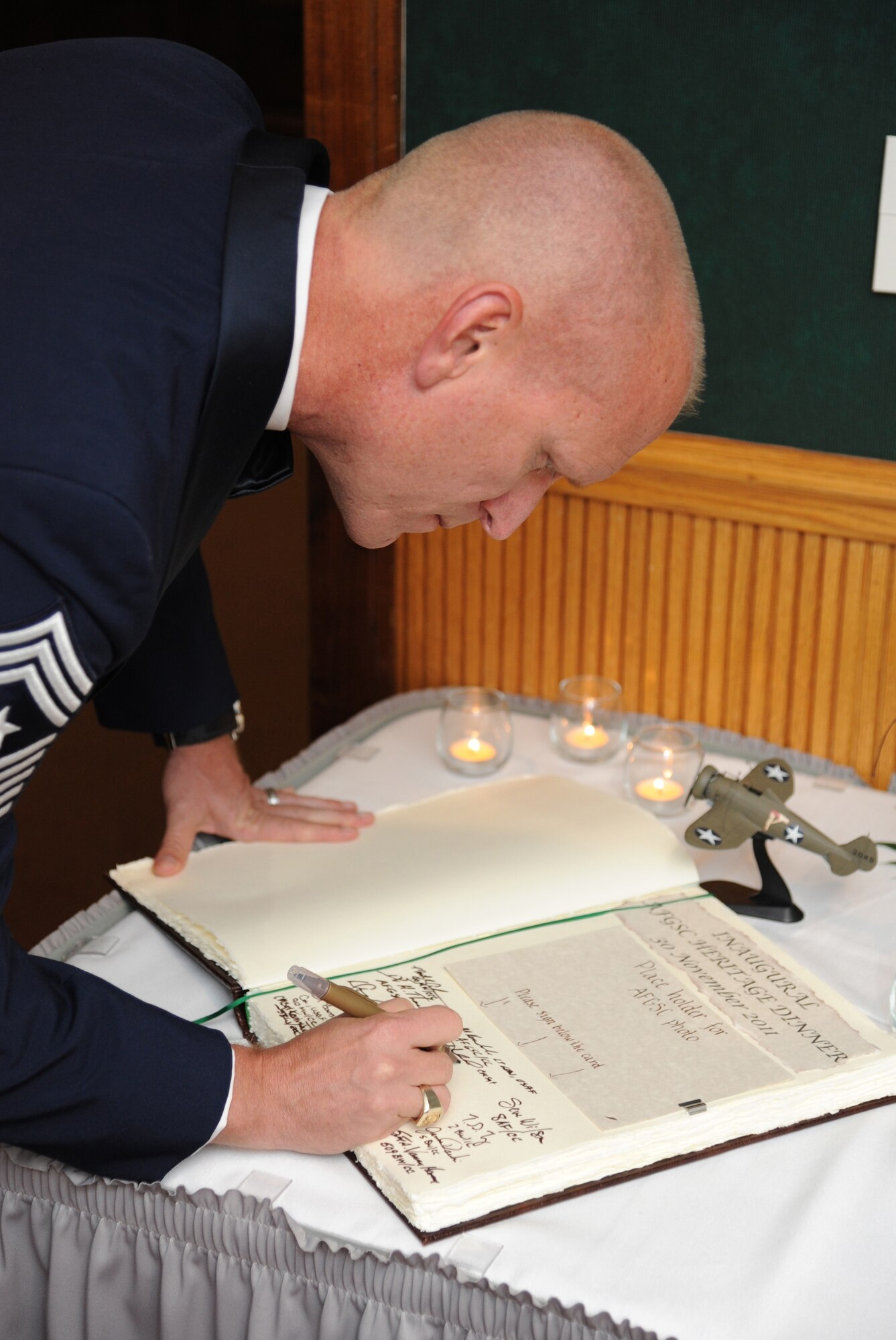 BARKSDALE AIR FORCE BASE, La. - Air Force Global Strike Command's Command Chief Master Sergeant Brian Hornback signs the AFGSC heritage book before the inaugural AFGSC Heritage Dinner, an effort to foster pride in the command's heritage and mission. The book holds select accounts of newly established AFGSC traditions since the command's activation. (U.S. Air Force photo by Master Sgt. Corey A. Clements)