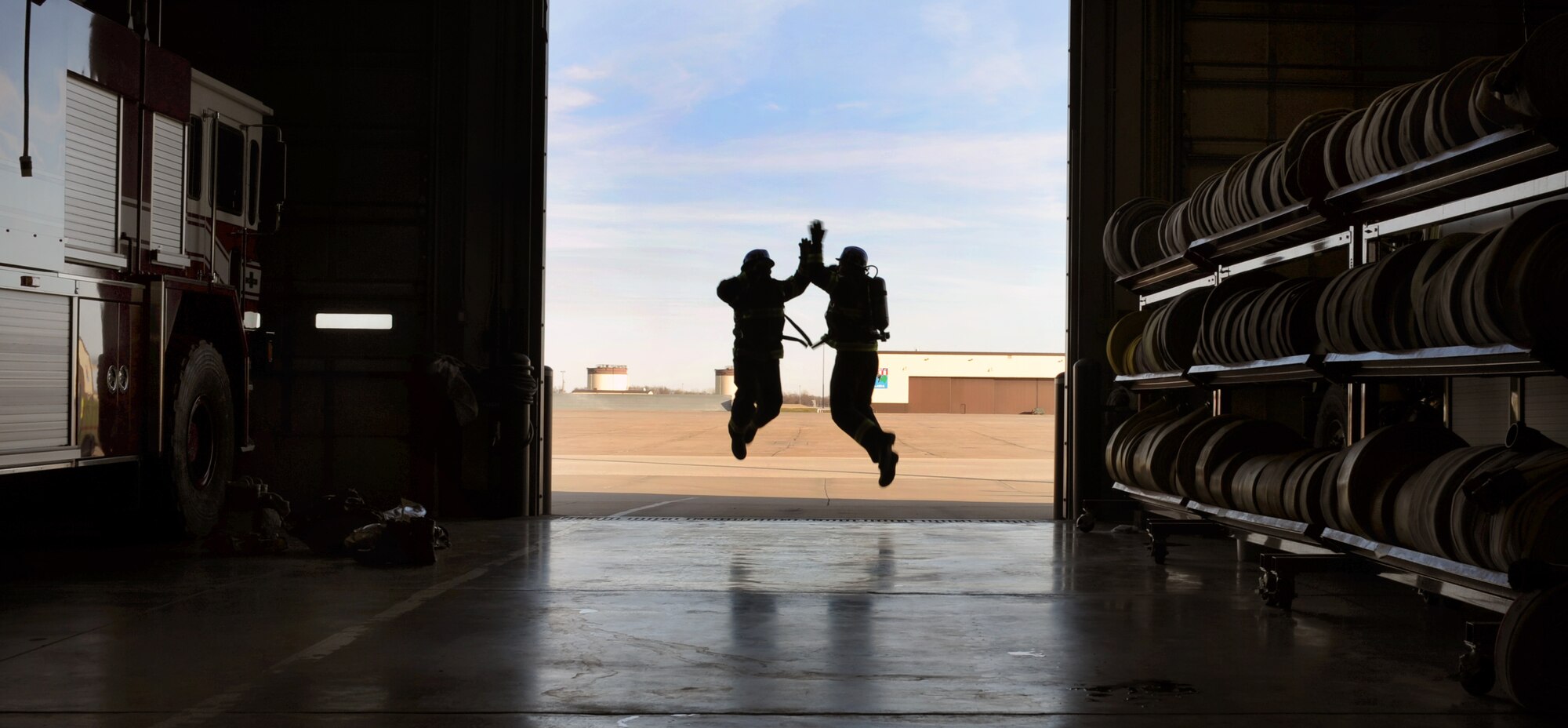 WHITEMAN AIR FORCE BASE, Mo. - - Staff Sgt. Derrick Allen and Senior Airman Timothy Vanden Haak give each other a high five after a brutal circuit workout Nov. 30. The Whiteman AFB team earned the silver medal this year at the world firefighter competition at Myrtle Beach, S.C. The challenge requires maximum effort in minimal time as it simulates the exertion needed to fight a fire and rescue a victim on a timed course. Vanden Haak placed 11th in the individual  portion of the world challenge out of 485 competitors. Allen and Vanden Haak are fire protection specialist assigned to the 509th Civil Engineer Squadron, Fire Protection Flight. (U.S. Air Force photo/Senior Airman Laura Goodgame) 