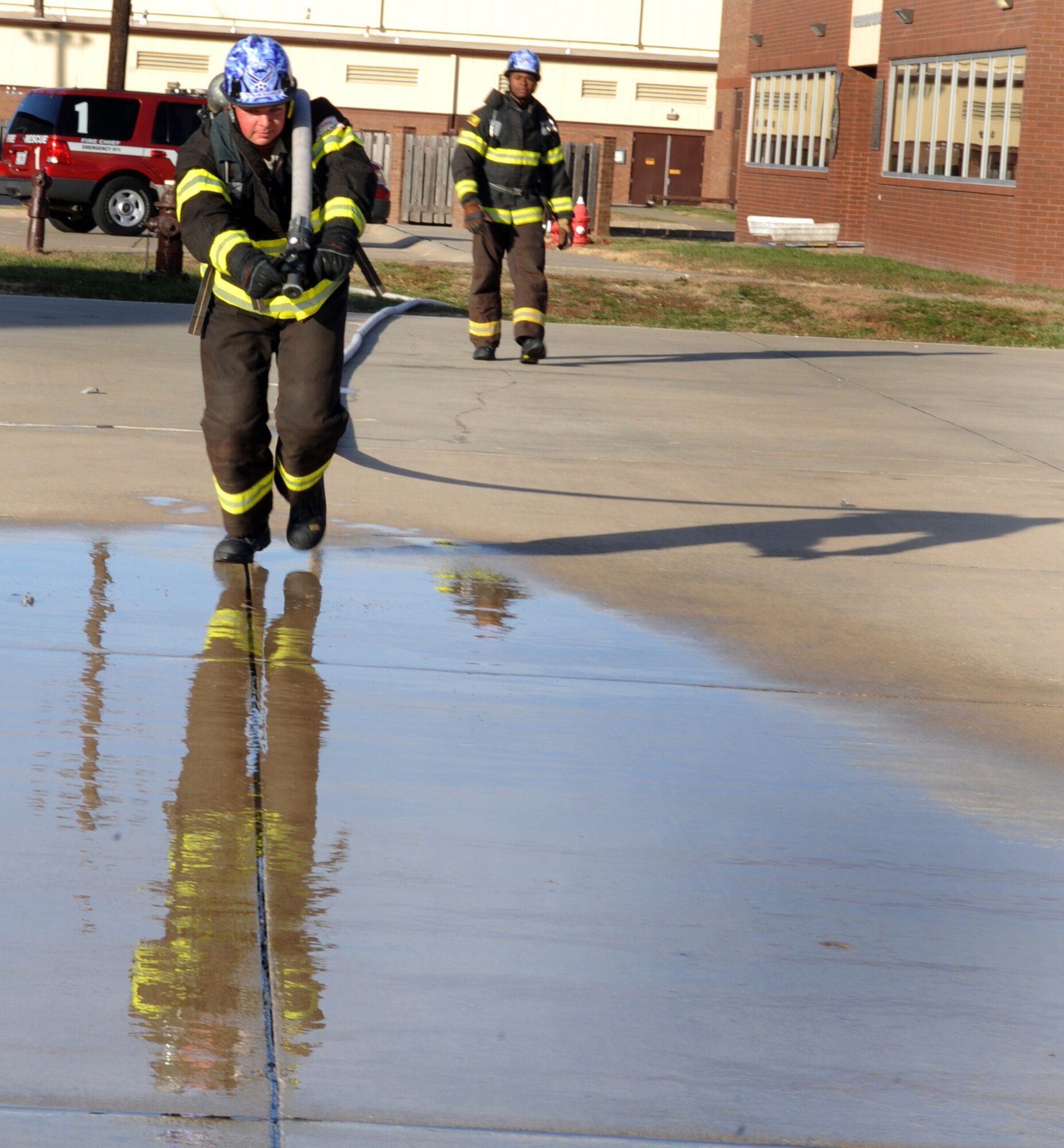 WHITEMAN AIR FORCE BASE, Mo. - - Senior Airman Timothy Vanden Haak hones his skills by practicing running with a fire hose in full gear Nov. 30. Vanden Haak placed 11th individual competition of the World Firefighter Combat Challenge held in Myrtle Beach, S.C. Nov. 19. The competition requires maximum effort in minimal time as it simulates the exertion needed to fight a fire and rescue a victim on a timed course. Air Force firefighters competed against their peers from Australia, Canada, Europe and the United States. Vanden Haak is a fire protection specialist assigned to the 509th Civil Engineer Squadron, Fire Protection Flight. (U.S. Air Force photo/Senior Airman Laura Goodgame) 