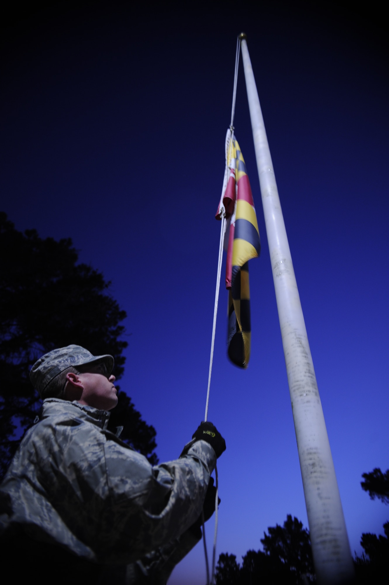VANDENBERG AIR FORCE BASE, Calif. -- Airman 1st Class Stephen Crookston, 30th Civil Engineer Squadron member, lowers a flag to half staff at the Avenue of flags here in honor of the 70th Anniversary of the attack at Pearl Harbor on the Avenue of Flags Wednesday, Dec. 7, 2011. The attack occurred on Pearl Harbor, Hawaii. (U.S. Air Force photo/Staff Sgt. Andrew Satran) 

 
 

 