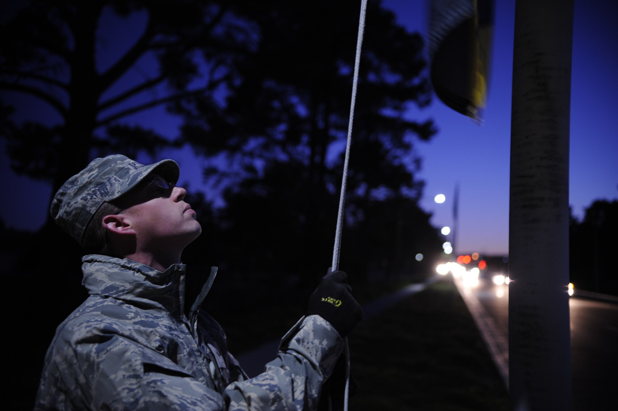 VANDENBERG AIR FORCE BASE, Calif. -- Airman 1st Class Stephen Crookston, 30th Civil Engineer Squadron member, lowers a flag to half staff at the Avenue of flags here in honor of the 70th Anniversary of the attack at Pearl Harbor on the Avenue of Flags Wednesday, Dec. 7, 2011. The attack occurred on Dec. 7, 1941, in Pearl Harbor, Hawaii, which resulted in 2,403 military members and civilians losing their lives.  (U.S. Air Force photo/Staff Sgt. Andrew Satran) 

 

 