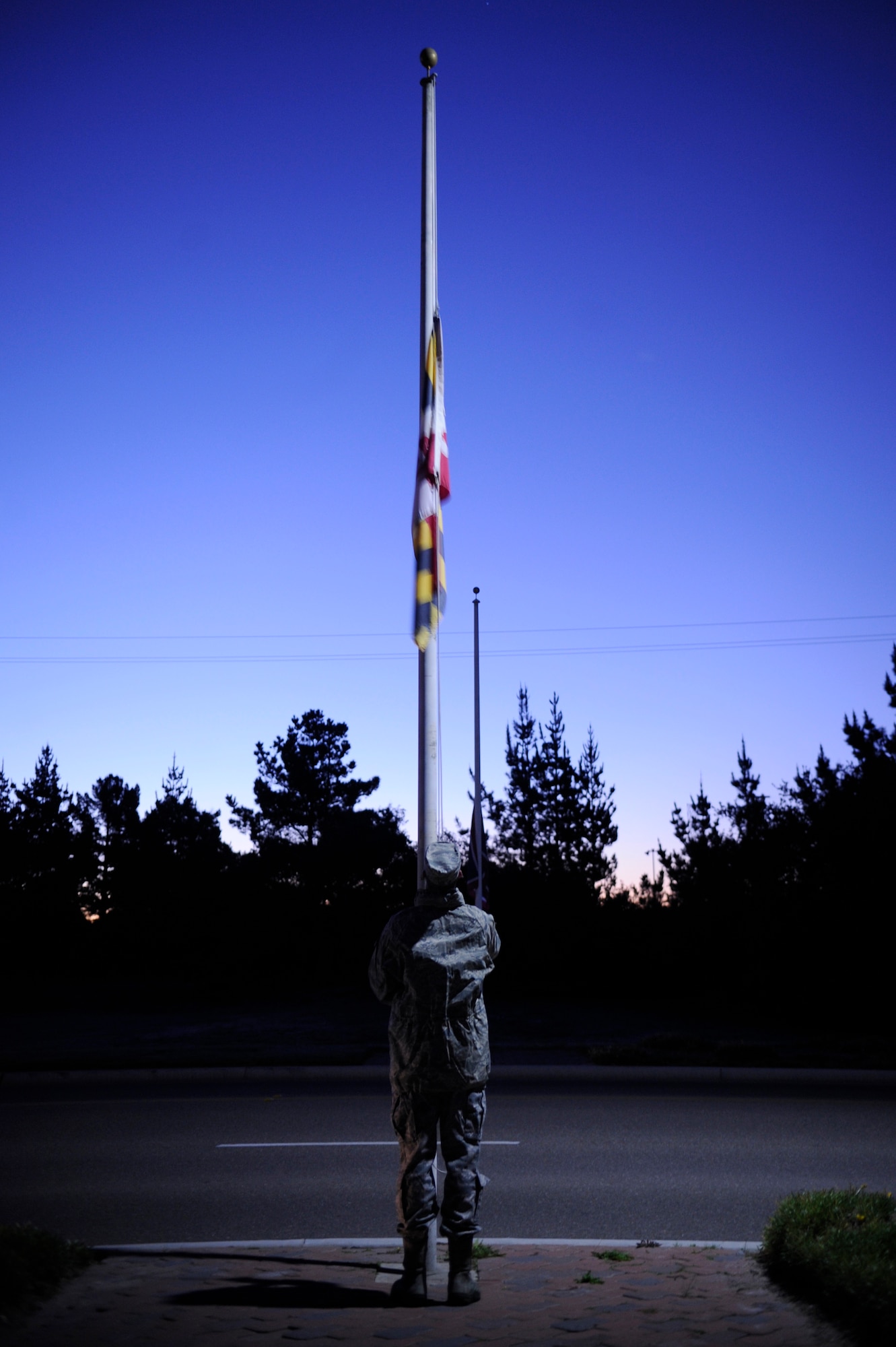 VANDENBERG AIR FORCE BASE, Calif. -- Airman 1st Class Stephen Crookston, 30th Civil Engineer Squadron member, lowers a flag to half staff at the Avenue of flags here in honor of the 70th Anniversary of the attack at Pearl Harbor on the Avenue of Flags Wednesday, Dec. 7, 2011. The attack occurred on Dec. 7, 1941, in Pearl Harbor, Hawaii, which resulted in 2,403 military members and civilians losing their lives.  (U.S. Air Force photo/Staff Sgt. Andrew Satran) 

 