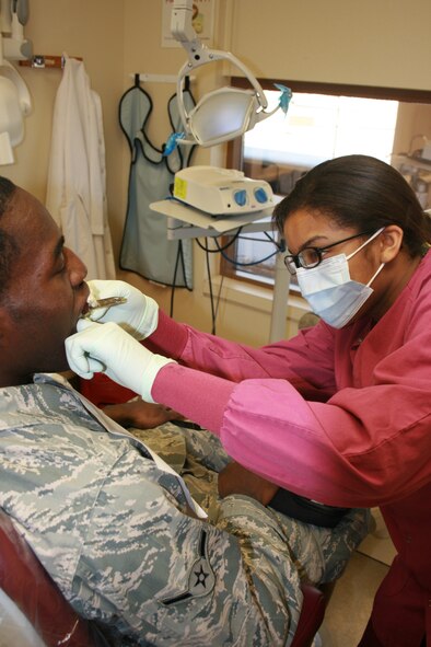 MINOT AIR FORCE BASE, N.D. -- Airman 1st Class Lachai Ross, 5th Medical Operations Squadron dental technician, prepares to mold a custom mouth guard for a patient here. Mouth guards protect against tooth injury, tooth loss, bone damage and also safeguards against serious jaw, head and brain injuries during sporting activities. (U.S. Air Force photo/Capt. Robert E. Wake)