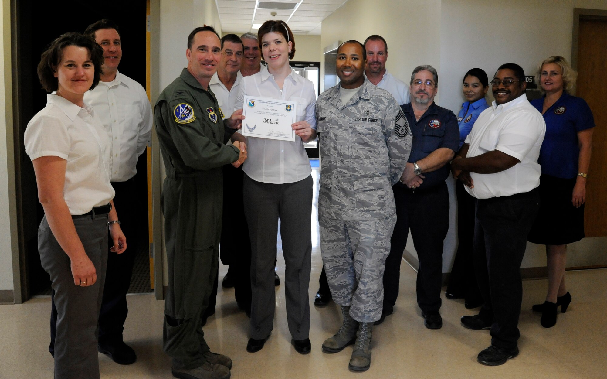 LAUGHLIN AIR FORCE BASE, Texas – Tara Jonson, 47th Flying Training Wing Maintenance Directorate secretary to the director of maintenance, poses with Col. Tom Murphy, 47th FTW commander, and Chief Master Sgt. Russell Thomas, 47th Medical Group superintendant, after being presented the XLer of the week award here Nov. 23. The XLer is a weekly award chosen by wing leadership and given to those who consistently make outstanding contributions to Laughlin and their unit. (U.S. Air Force photo/Airman 1st Class Nathan L. Maysonet)