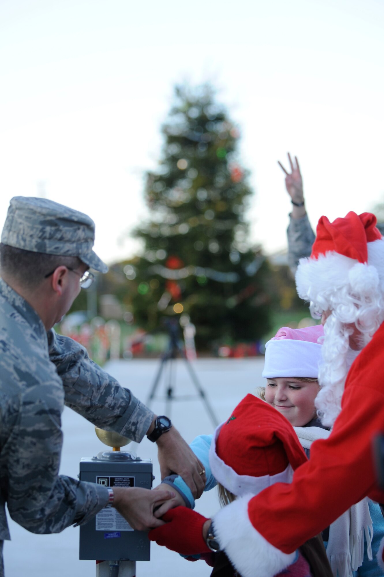 VANDENBERG AIR FORCE BASE, Calif. -- Col. Keith Balts, 30th Space Wing vice commander, two members from the Space and Sea Girl Scout troop and Santa Claus pull the lever to light the tree during the base tree lighting event here Tuesday, Dec. 6, 2011. (U.S. Air Force photo/Staff Sgt. Andrew Satran) 

 
   