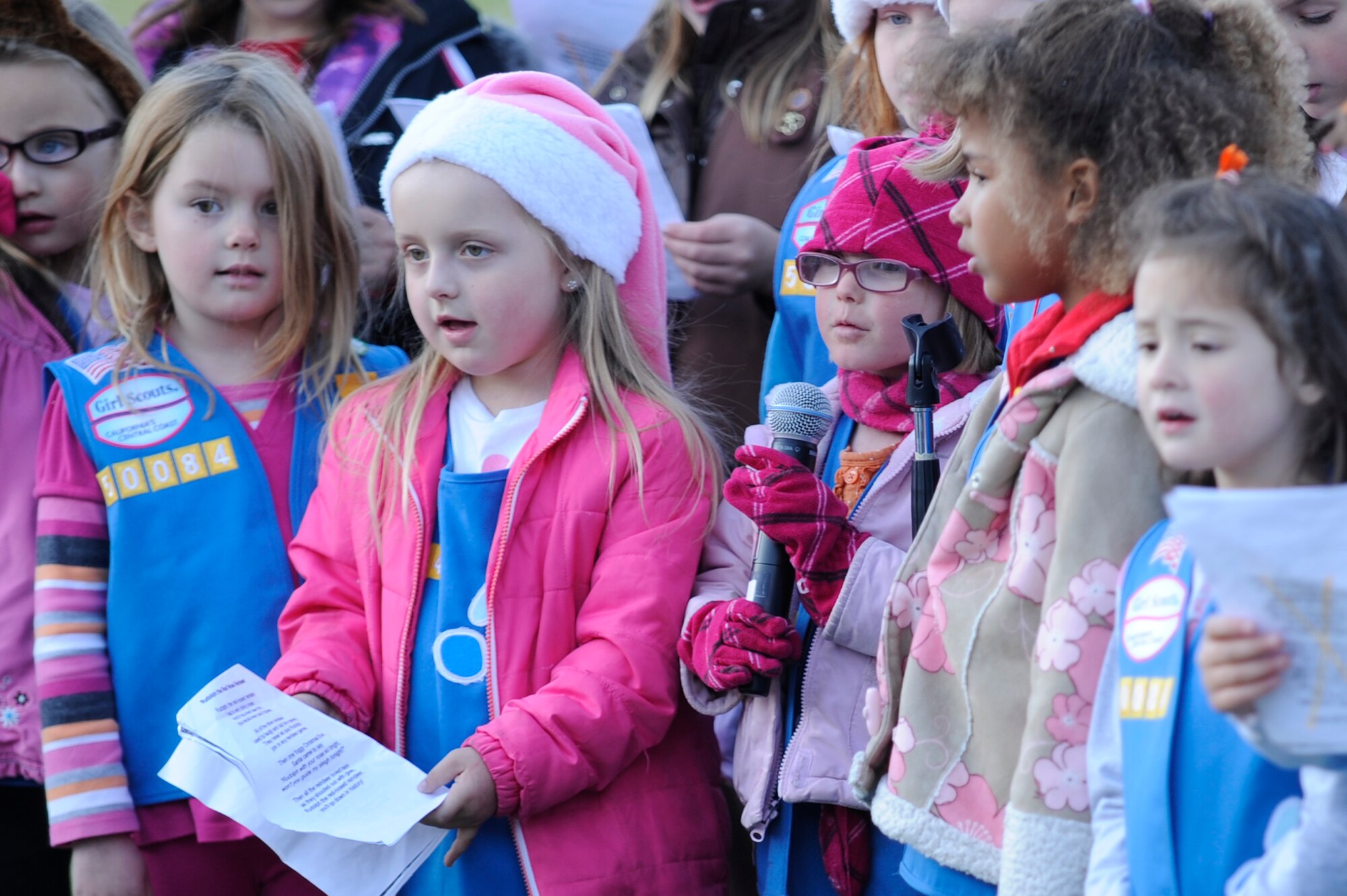 VANDENBERG AIR FORCE BASE, Calif. -- The Space and Sea Girl Scout troops sing a holiday song during the base tree lighting event here Tuesday, Dec. 6, 2011.  The troop sang many songs throughout the event. (U.S. Air Force photo/Staff Sgt. Andrew Satran) 

 