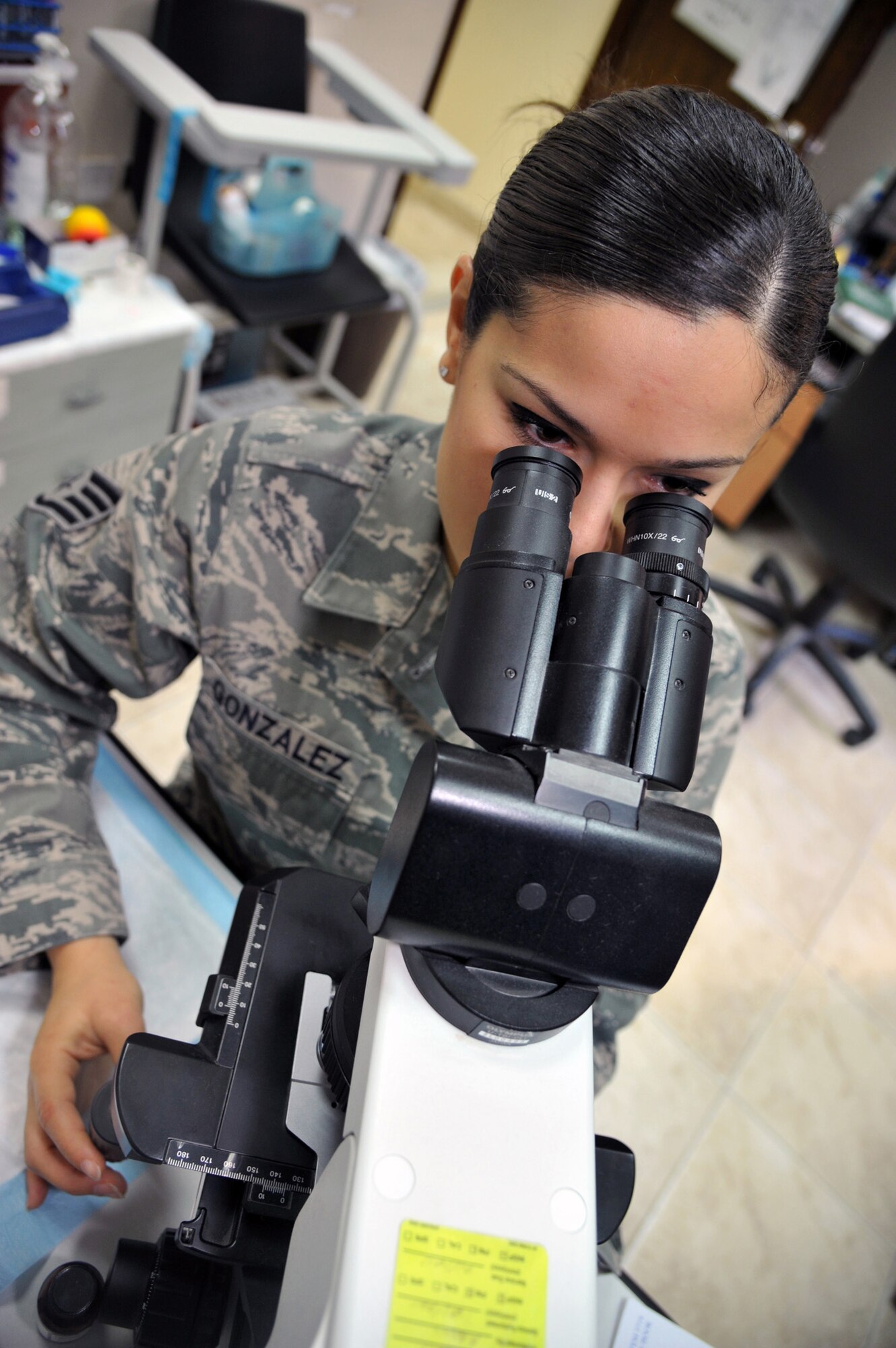 Staff Sgt. Lluvia L. Gonzalez is performing a microscopic urinalysis as part of her duties as a Medical Laboratory technician at the 386th Expeditionary Medical Group, Nov. 8, at an undisclosed location in Southwest Asia. Gonzalez is currently deployed from Eglin Air Force Base, Fla.  (U.S. Air Force photo/Carlotta Holley)
